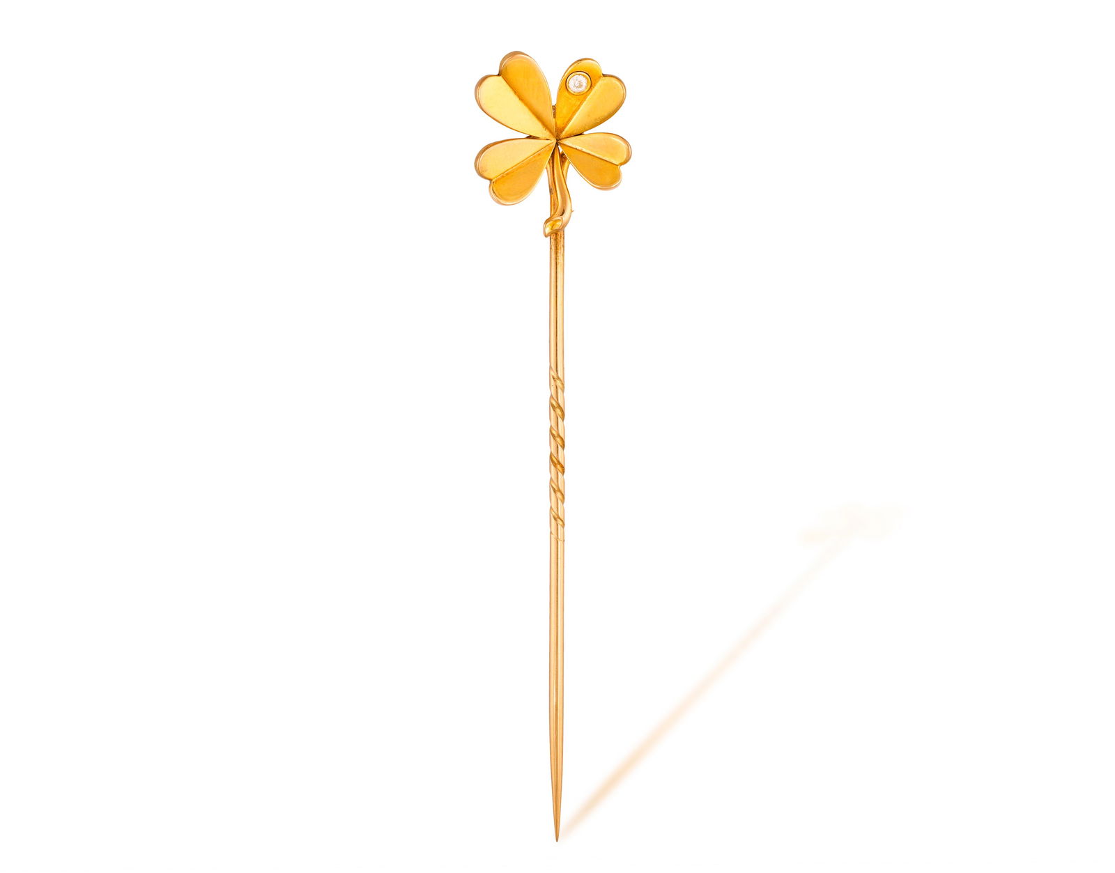 A CLOVER DIAMOND TIE-PIN * one brilliant-cut diamond * mounted in gold * length 8cm * This lot is (1 of 2)