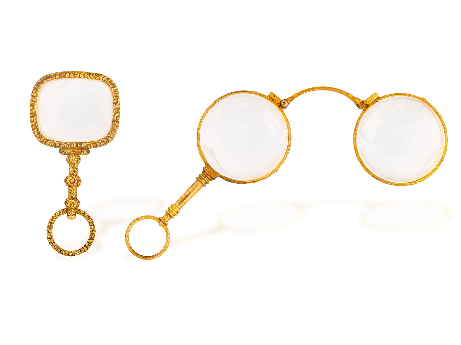 TWO LATE 19TH CENTURY LORGNETTES * one rectangular glass with engraved foliate motif frame and: TWO LATE 19TH CENTURY LORGNETTES * one rectangular glass with engraved foliate motif frame and handle * in 14K gold * length 8cm |One circular glass with engraved motifs frame and handle * 18K gold an
