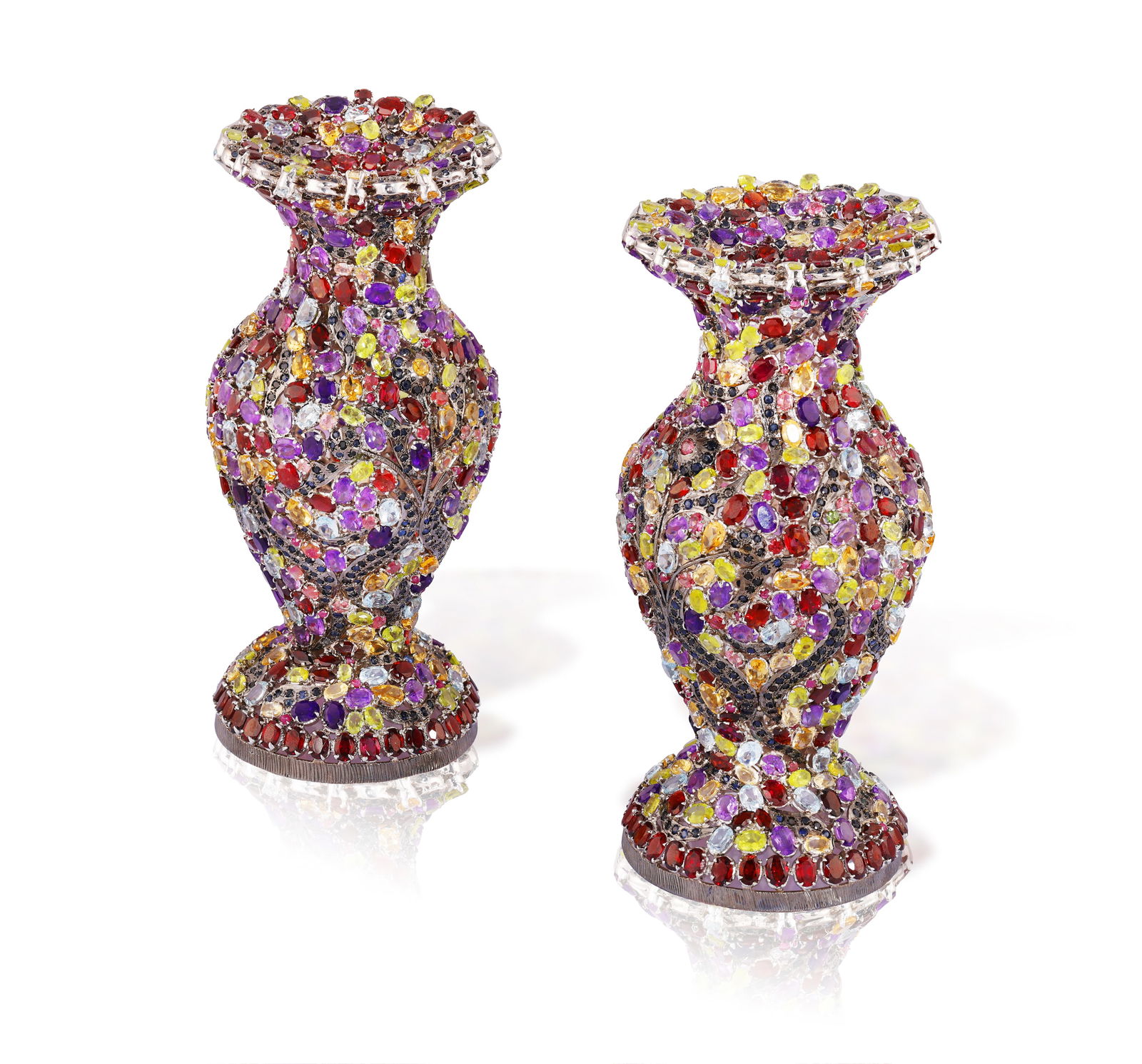 A PAIR OF GEM-SET CANDLE STICKS * oval-shaped periodots, amethysts, and probably aquamarines * (1 of 2)