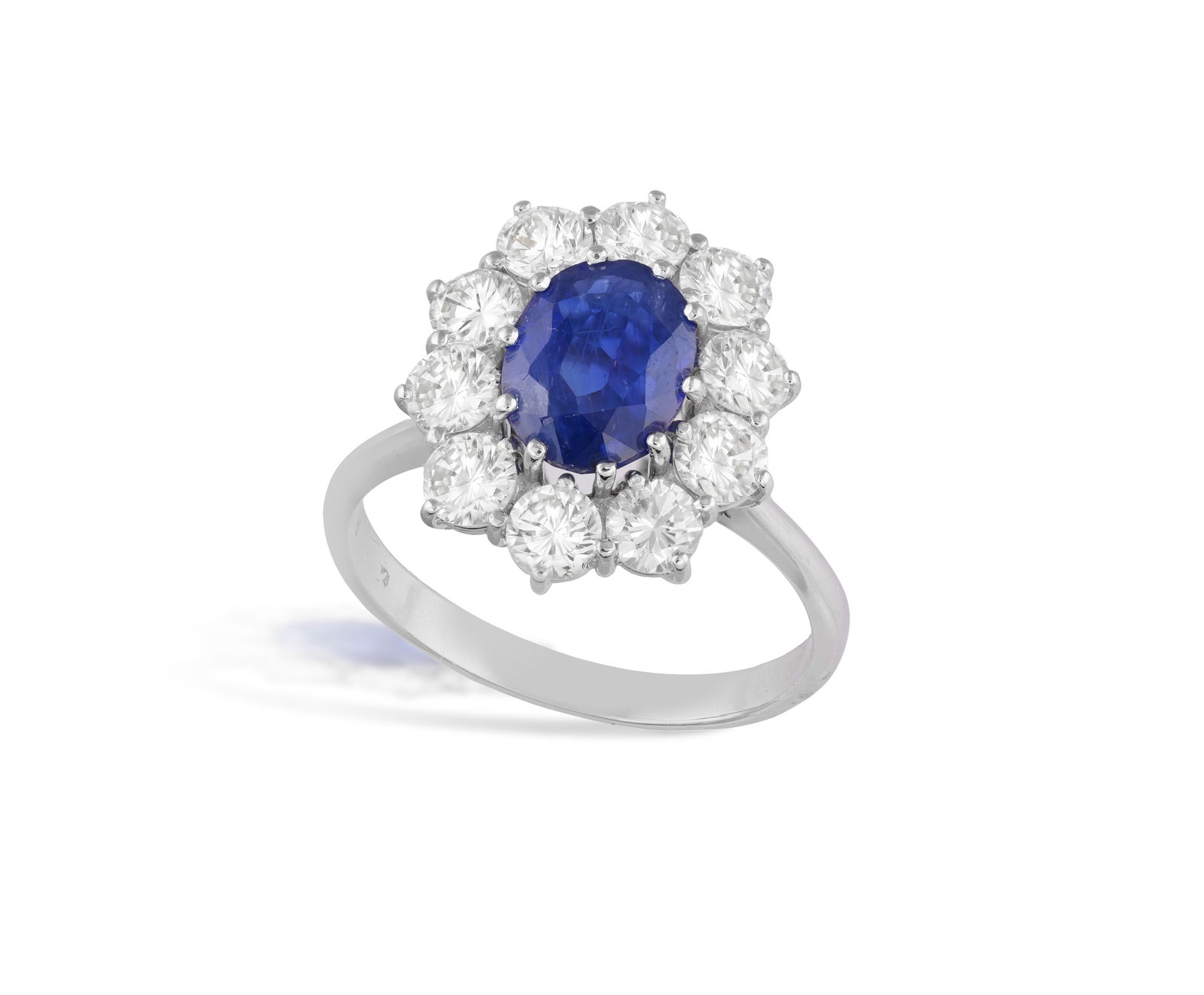 A SAPPHIRE AND DIAMOND CLUSTER RING * an oval-shaped sapphire, approx. 1.50cts * brilliant-cut (1 of 4)