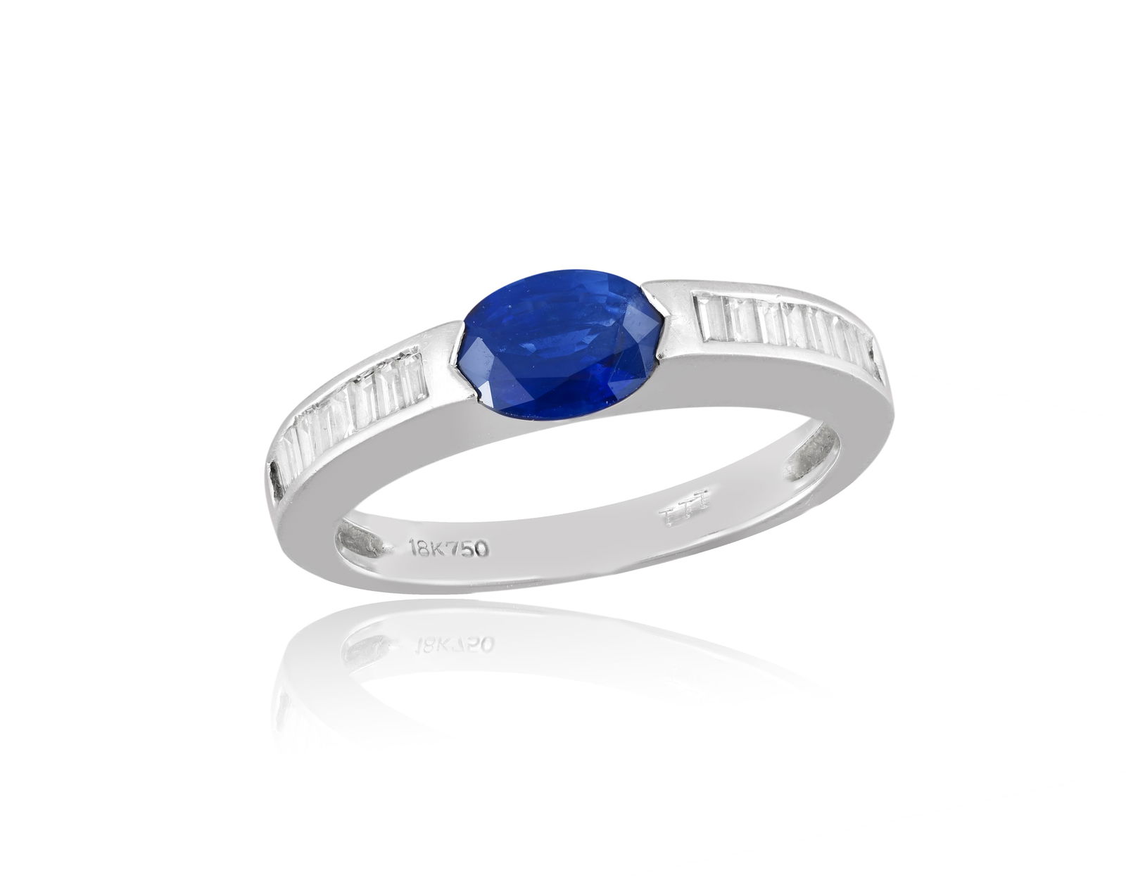 A SAPPHIRE AND DIAMOND RING * an oval-shaped sapphire * brilliant and baguette-cut diamonds *: A SAPPHIRE AND DIAMOND RING * an oval-shaped sapphire * brilliant and baguette-cut diamonds * mounted in 18K gold * ring size M