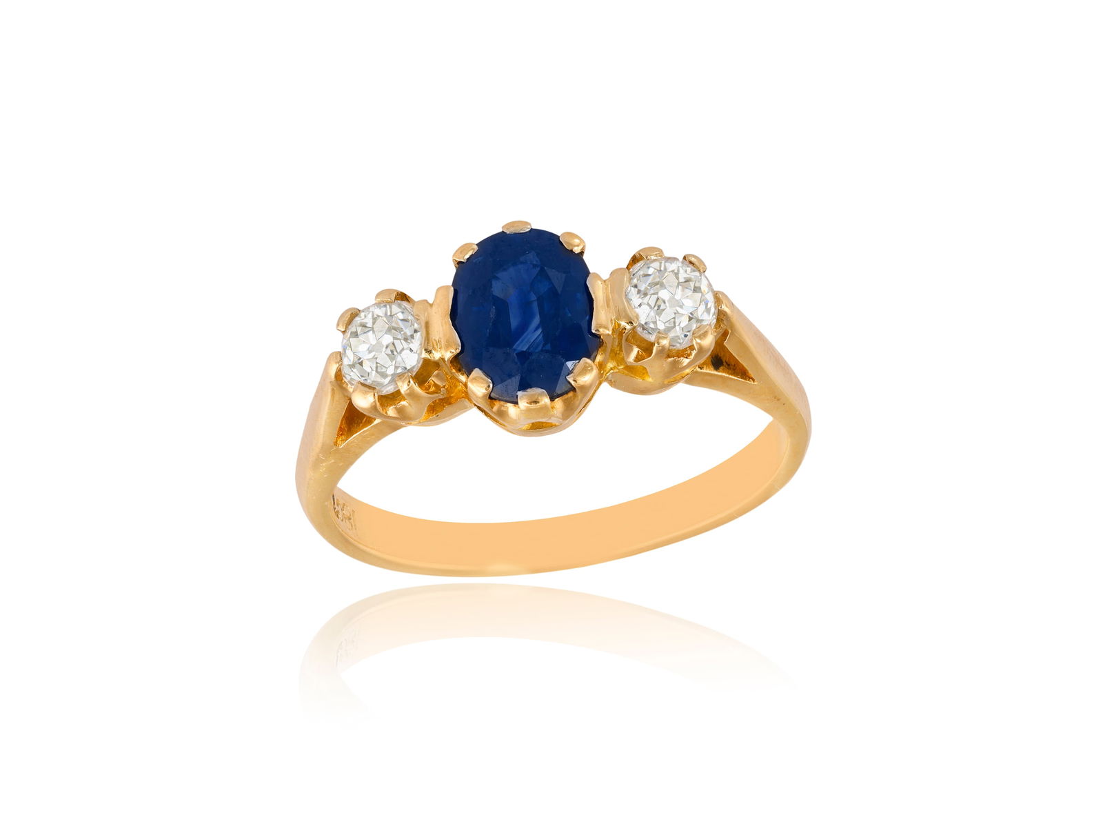 A SAPPHIRE AND DIAMOND RING * an oval-shaped sapphire * two old brilliant-cut diamonds * mounted in (1 of 2)