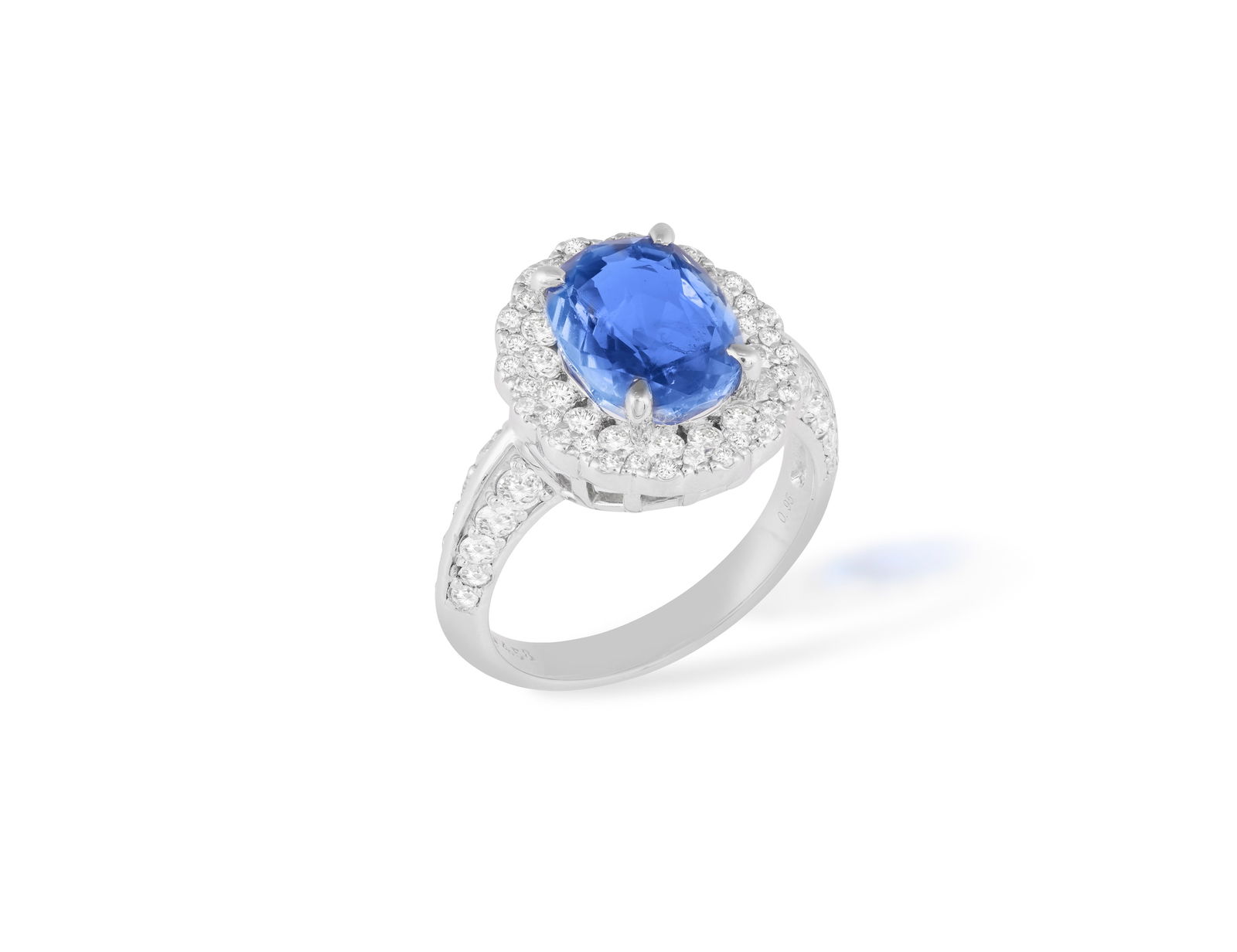 A SAPPHIRE AND DIAMOND CLUSTER RING * an oval-shaped sapphire * brilliant-cut diamonds, approx. (1 of 4)