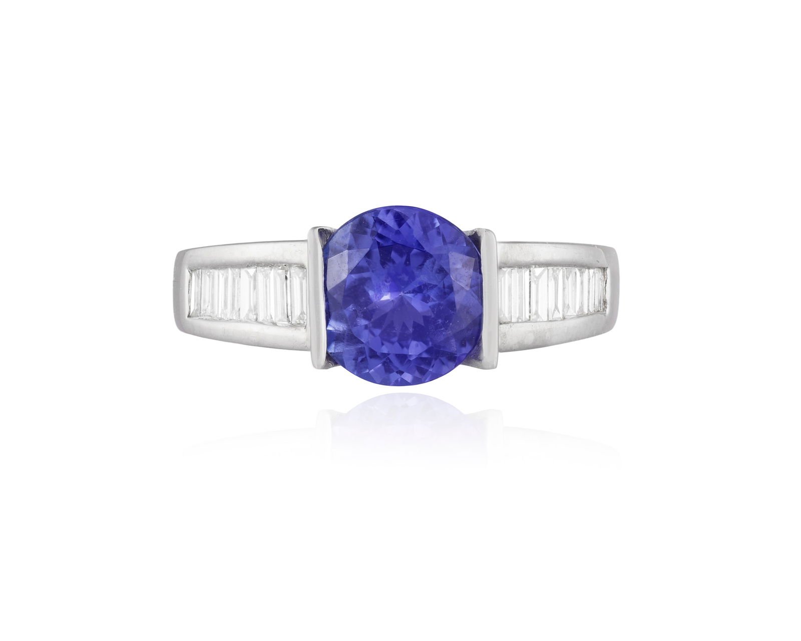 A TANZANITE AND DIAMOND RING * a circular-cut tanzanite * baguette-cut diamonds * mounted in 18K (1 of 4)