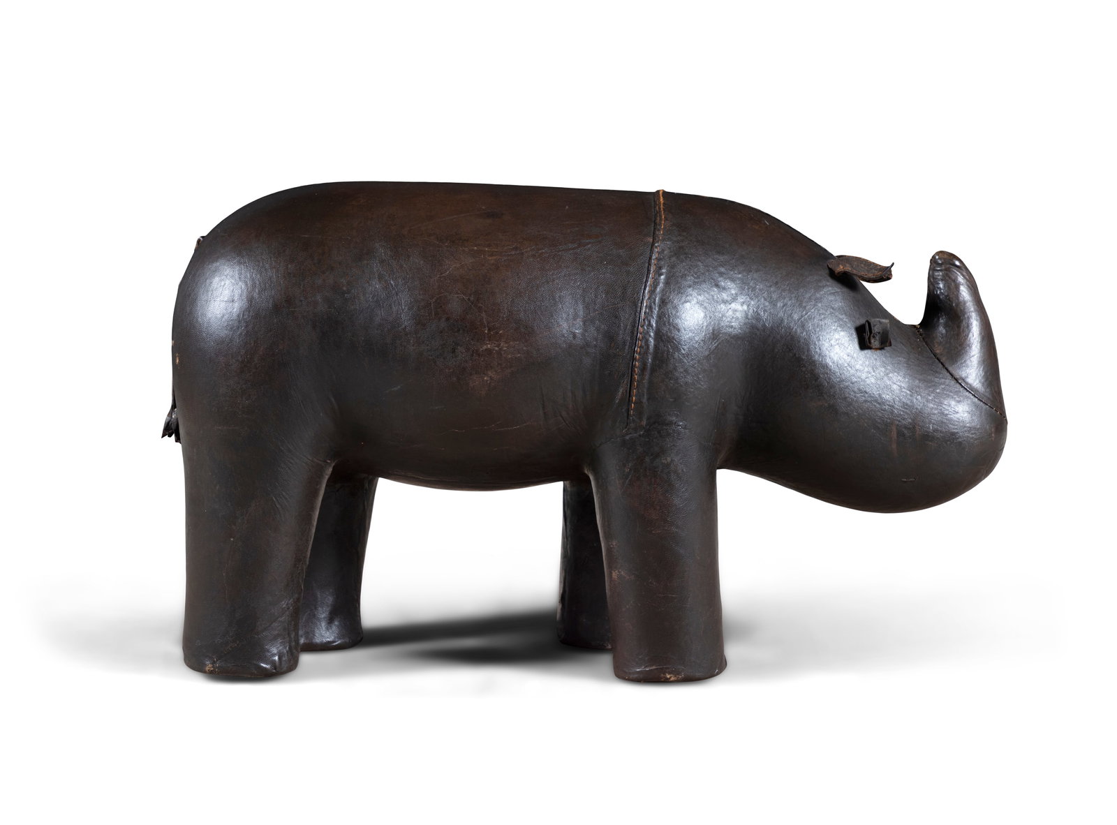 FOOTSTOOL A brown leather Rhino Footstool attributed to Dimitri Omersa. 64 x 28 x 35cm(h): FOOTSTOOL A brown leather Rhino Footstool attributed to Dimitri Omersa. 64 x 28 x 35cm(h)