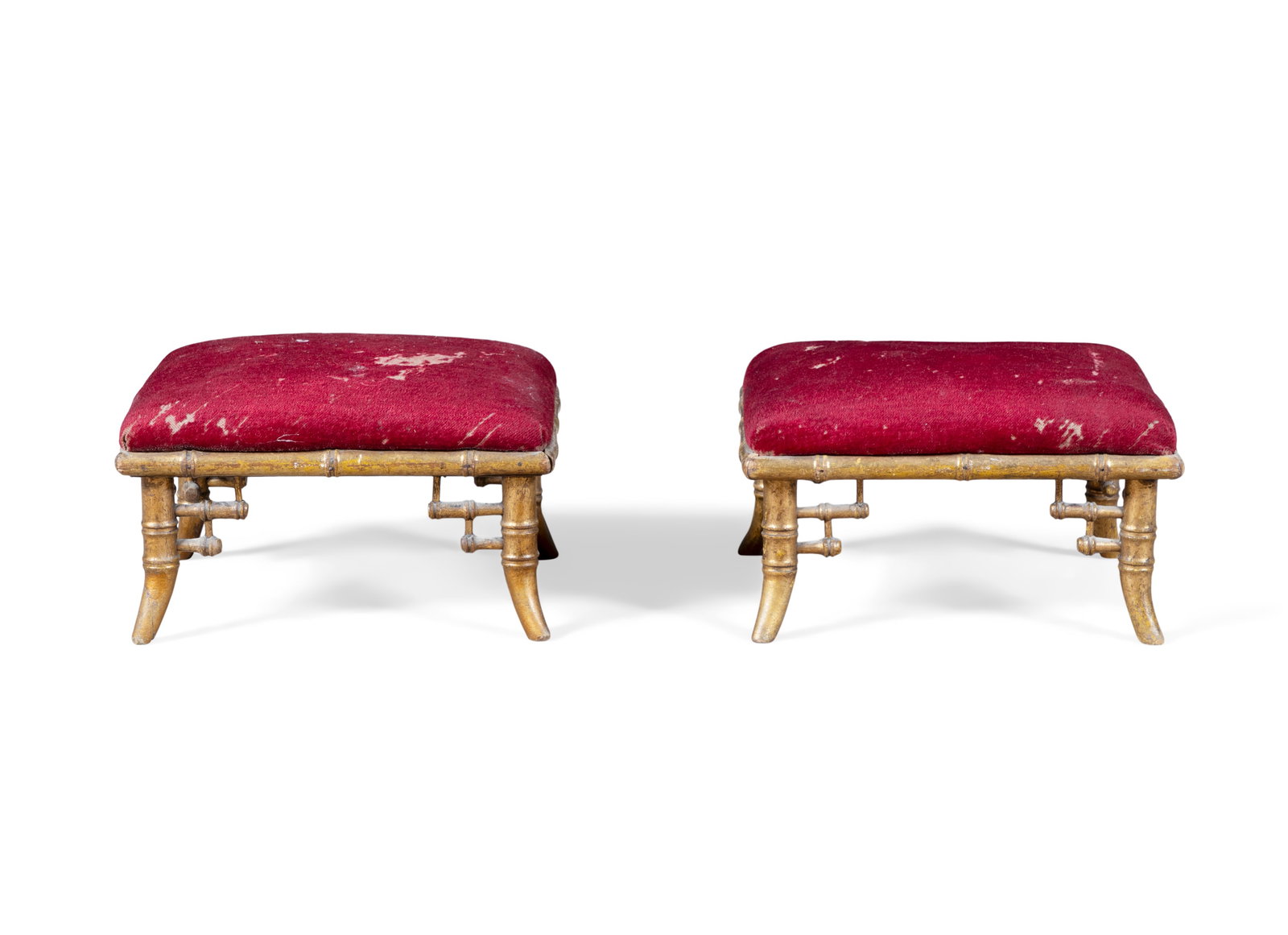 A PAIR OF GILTWOOD SIMULATED BAMBOO FOOT STOOLS the tops upholstered in red fabric, 15cm high,: A PAIR OF GILTWOOD SIMULATED BAMBOO FOOT STOOLS the tops upholstered in red fabric, 15cm high, 30cm wide, 26cm deep