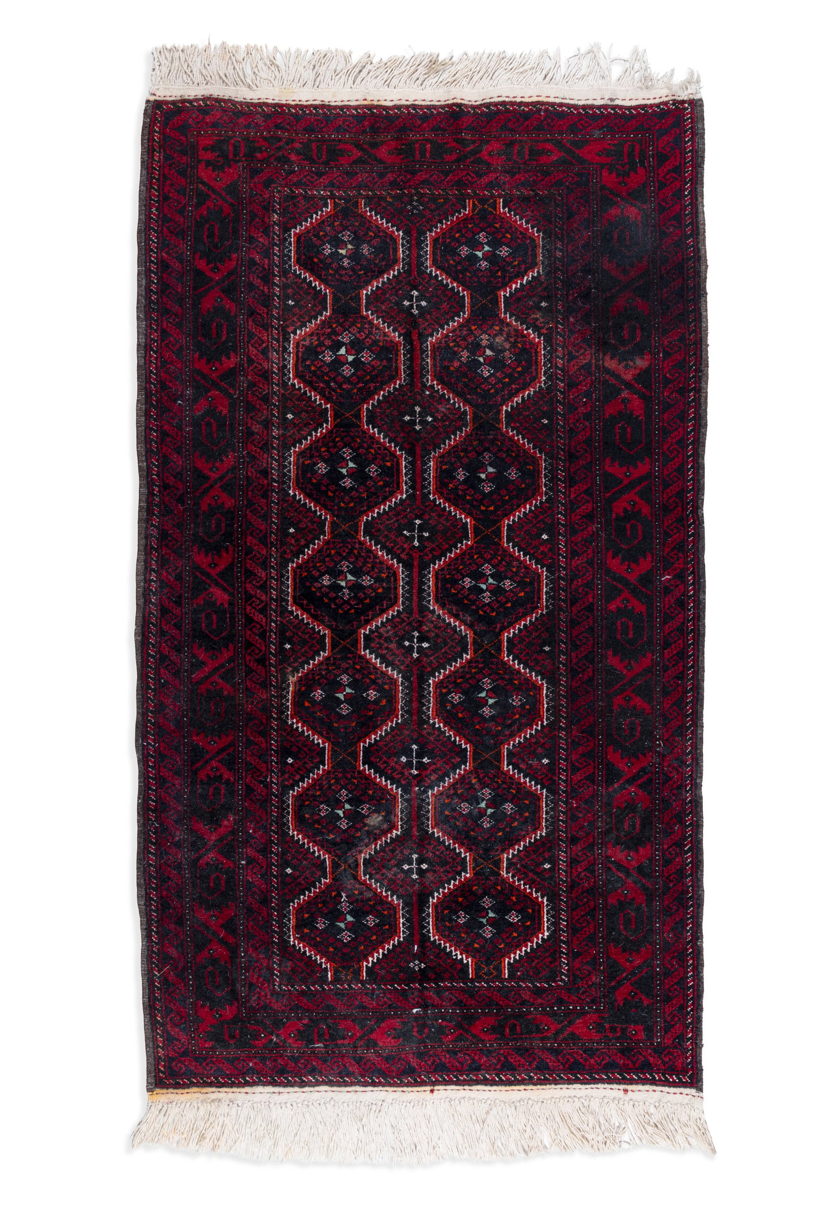 AN AFGHAN BALUCHI WOOL RUG, 20TH CENTURY. 160 x 93CM the deep blue rectangular field woven with: AN AFGHAN BALUCHI WOOL RUG, 20TH CENTURY. 160 x 93CM the deep blue rectangular field woven with two columns of interlinking octagons in red and off-white tones, with geometric outer borders and fringe