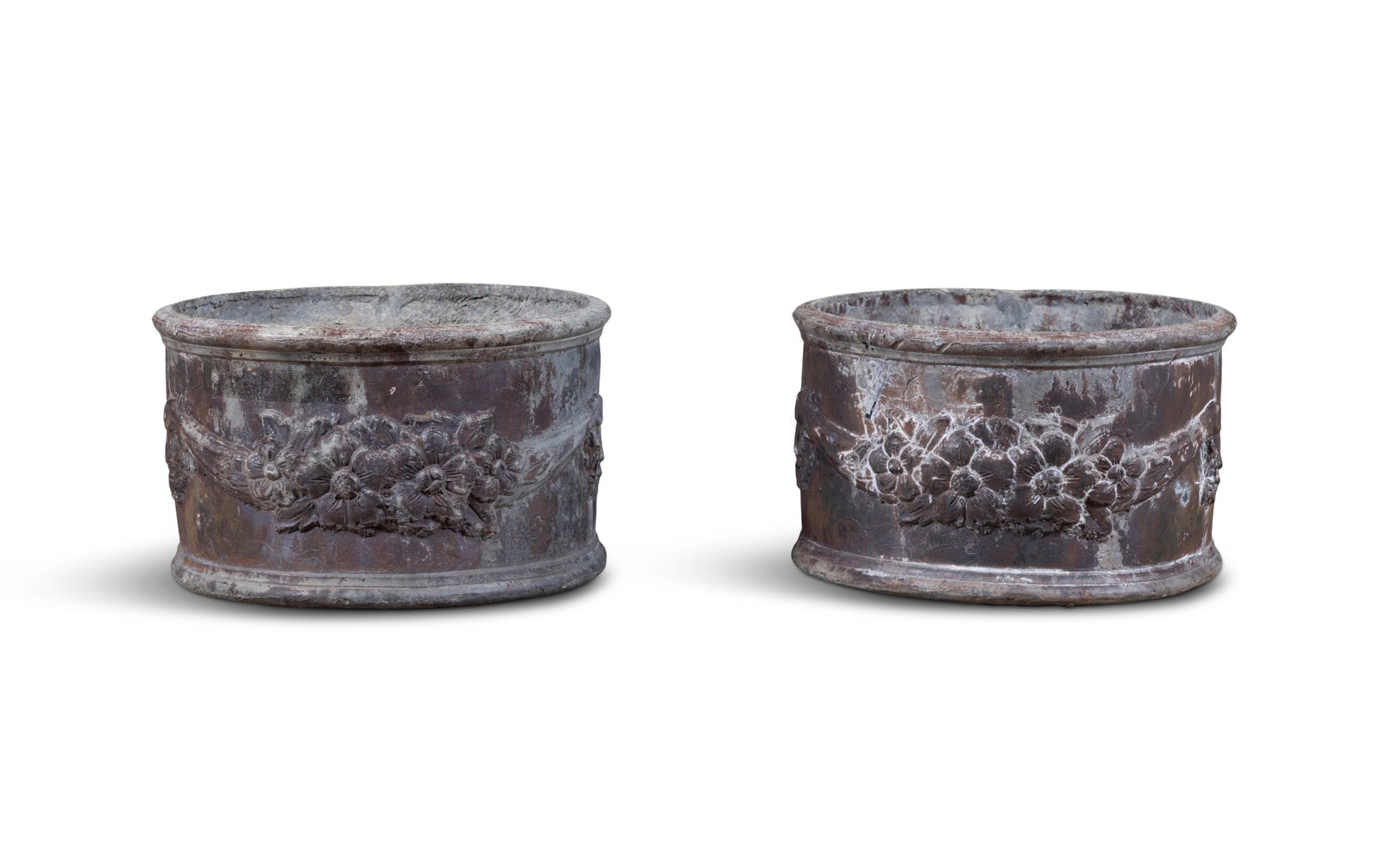 A PAIR OF SMALL VICTORIAN CYLINDRICAL LEAD PLANTERS, decorated with floral swags. 32.5cm high, (1 of 5)