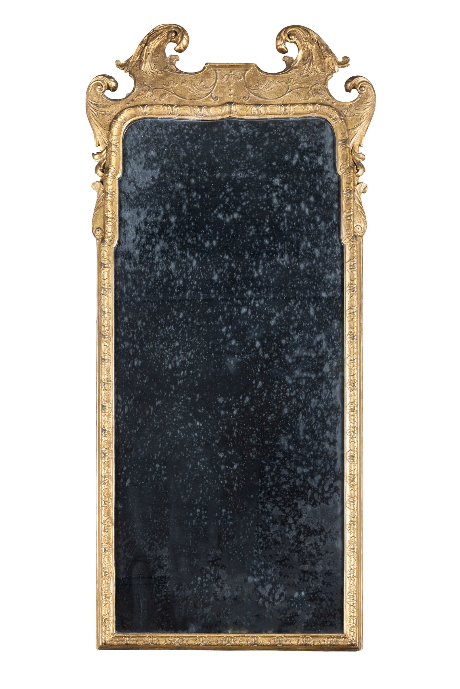 A GEORGE II FLAT CARVED GILTWOOD PIER MIRROR, the shaped rectangular glass plate contained within a: A GEORGE II FLAT CARVED GILTWOOD PIER MIRROR, the shaped rectangular glass plate contained within a leaf carved frame with scrollwork pediment. 149cm high, 66cm wide
