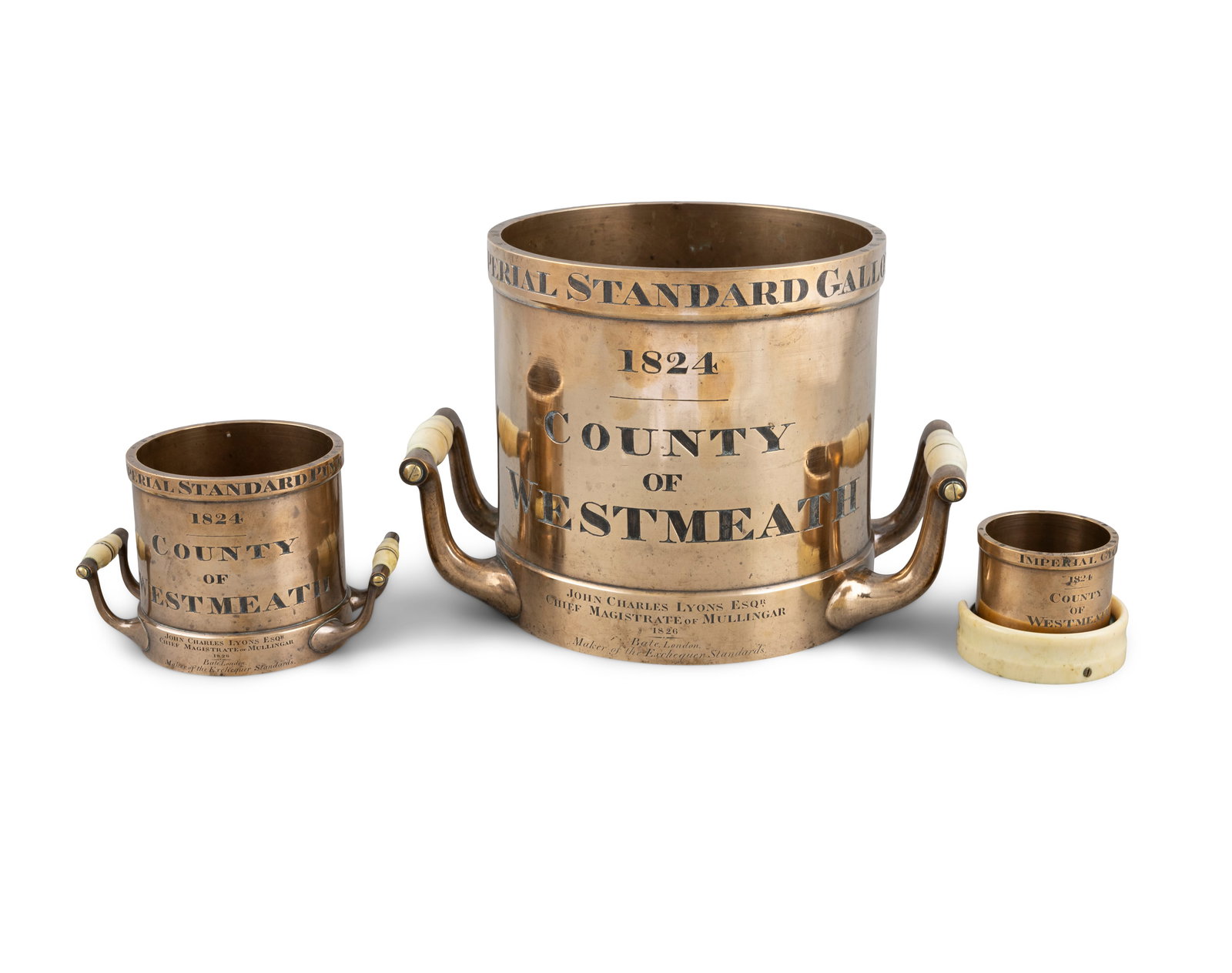 A SET OF THREE 'COUNTY OF WESTMEATH' FIRST EDITION IMPERIAL BRONZE MEASURES, 1824 BY BATES, LONDON: A SET OF THREE 'COUNTY OF WESTMEATH' FIRST EDITION IMPERIAL BRONZE MEASURES, 1824 BY BATES, LONDON FOR JOHN CHARLES ESQ. CHIEF MAGISTRATE OF MULLINGAR (1826) comprising a Gallon, Pint and Gill, with i