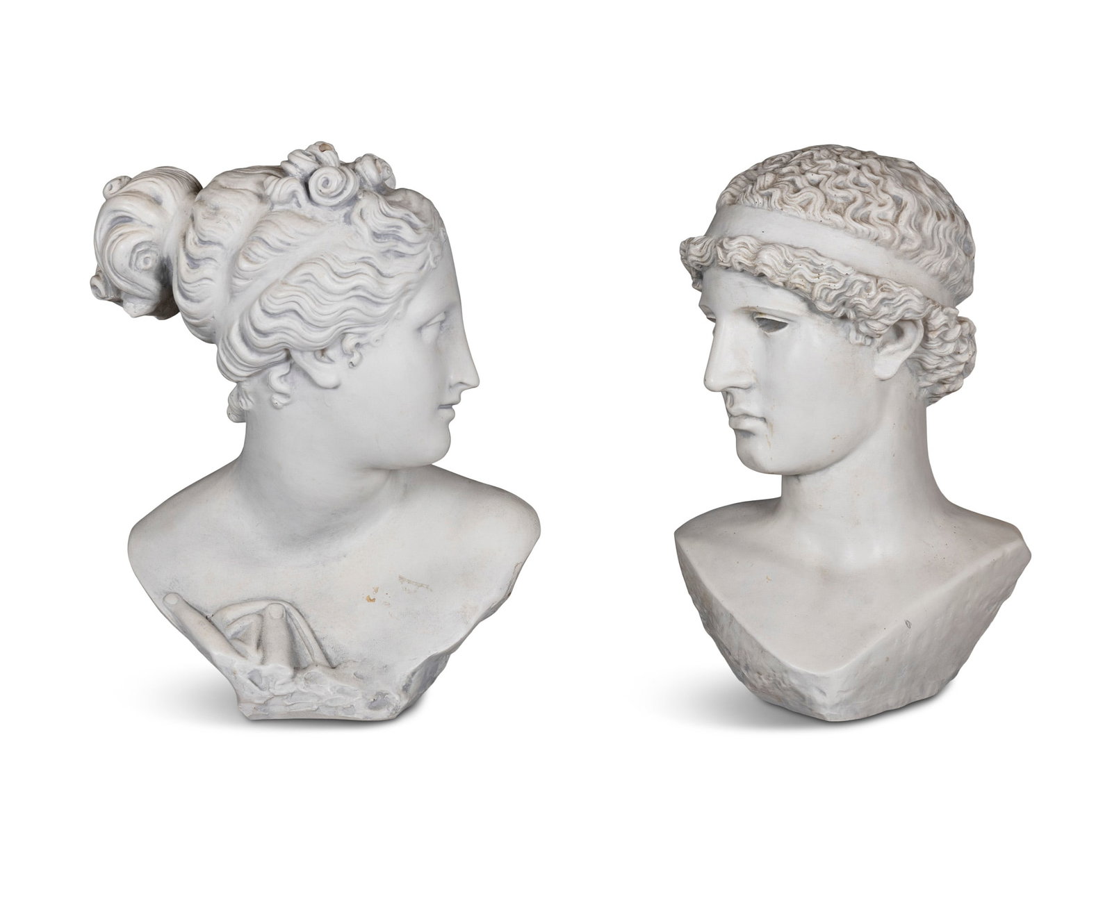 A PAIR OF PLASTER CAST BUSTS OF CLASSICAL MALE AND FEMALE FIGURES, modelled facing each other (1 of 2)
