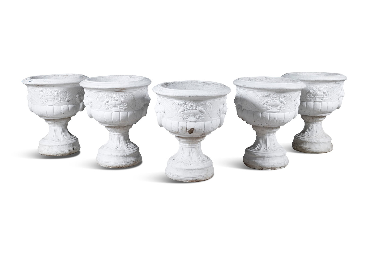 A COLLECTION OF FIVE WHITE PAINTED GARDEN URNS, 20TH CENTURY, each with carved lion head loop twin: A COLLECTION OF FIVE WHITE PAINTED GARDEN URNS, 20TH CENTURY, each with carved lion head loop twin handle decoration, demi-fluted, raised on socle bases. 54cm diameter, 66cm high