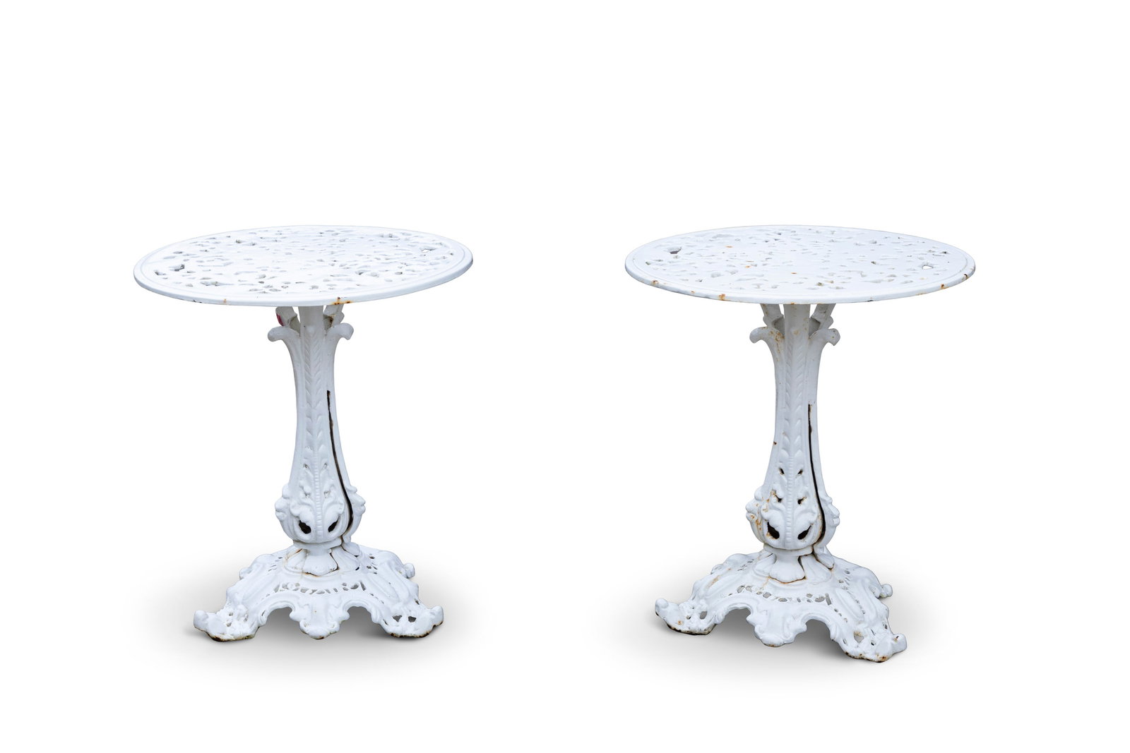 A PAIR OF VICTORIAN CAST IRON WHITE PAINTED GARDEN TABLES, circular pierced top on leaf carved (1 of 3)