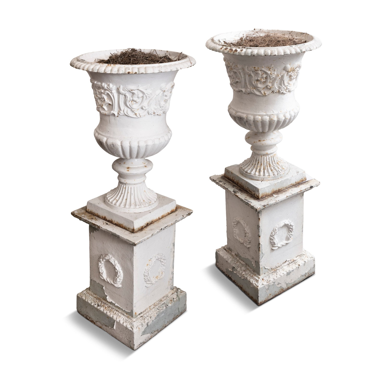 A PAIR OF WHITE PAINTED CAST IRON GARDEN URNS, 19TH CENTURY, Campagna form, demi-fluted bodies: A PAIR OF WHITE PAINTED CAST IRON GARDEN URNS, 19TH CENTURY, Campagna form, demi-fluted bodies decorated with bands of scrolling foliage on waisted socle raised on square plinth bases, decorated with 