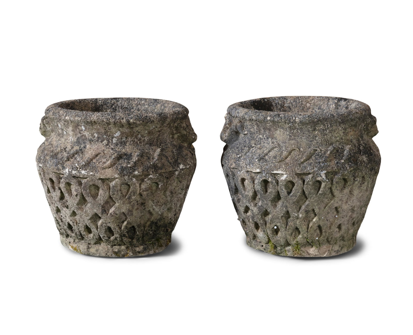 A PAIR OF ENGLISH COMPOSITE STONE URNS, Upright baluster form, carved interlaced pattern to the: A PAIR OF ENGLISH COMPOSITE STONE URNS, Upright baluster form, carved interlaced pattern to the bodies, 27.5cm high, 26cm diameter