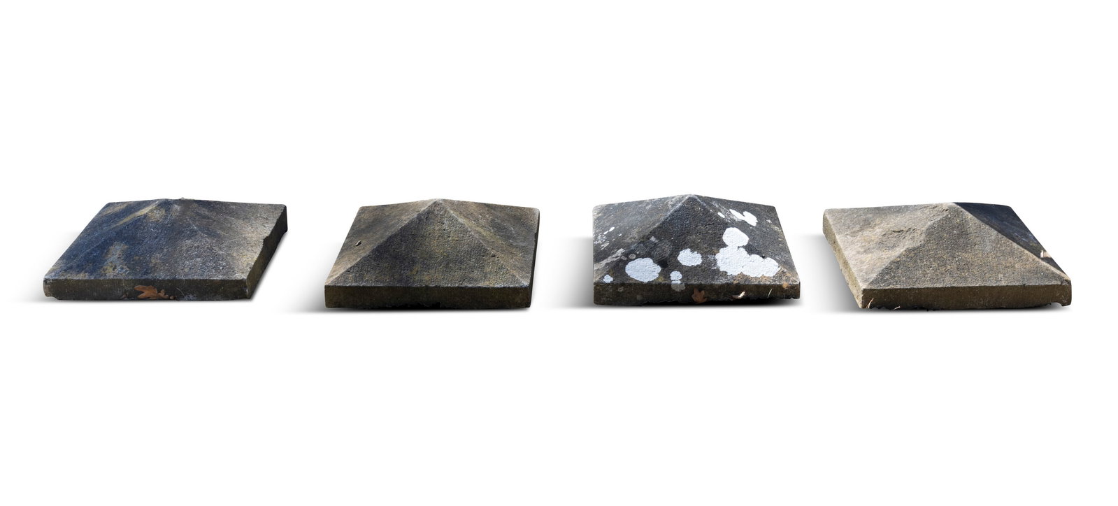 A SET OF FOUR STONE CAPS, of compressed pyramid form. 40 x 40 x 12cm high: A SET OF FOUR STONE CAPS, of compressed pyramid form. 40 x 40 x 12cm high