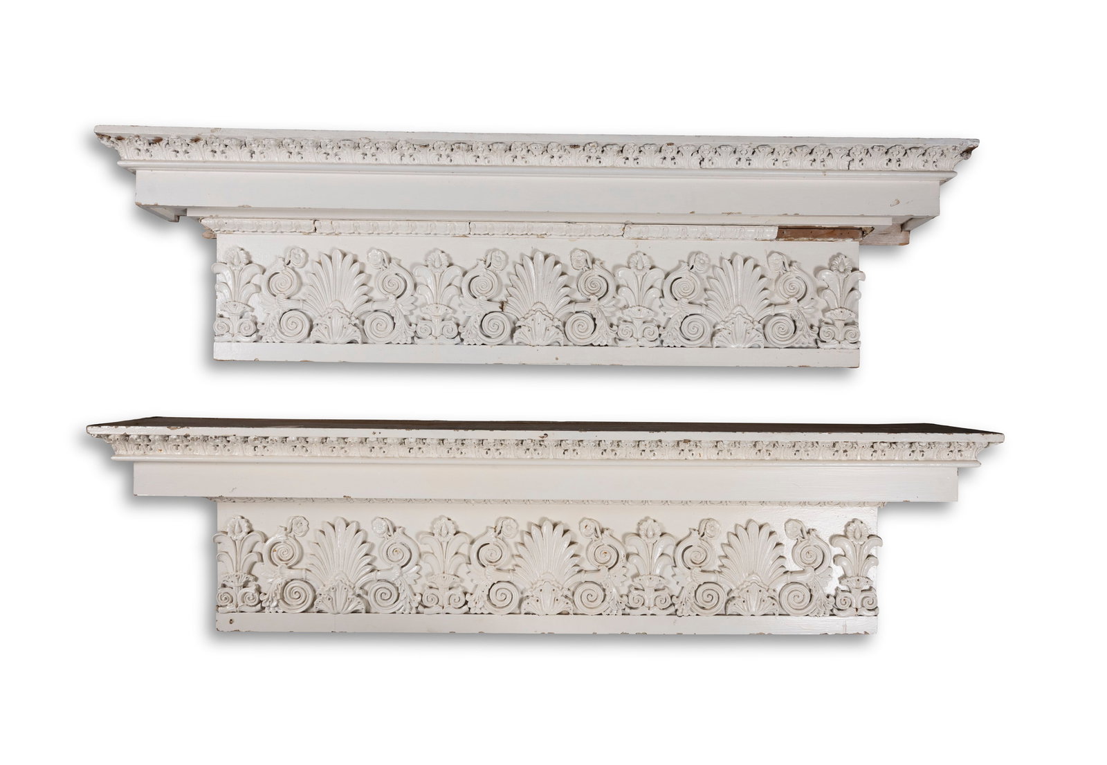 A SET OF FOUR CARVED AND WHITE PAINTED PINE DOOR CAPITALS, outset cornice with carved acanthus: A SET OF FOUR CARVED AND WHITE PAINTED PINE DOOR CAPITALS, outset cornice with carved acanthus leaf, over egg-and-dart moulding the frieze, acanthus leaf and scroll work, 168cm wide