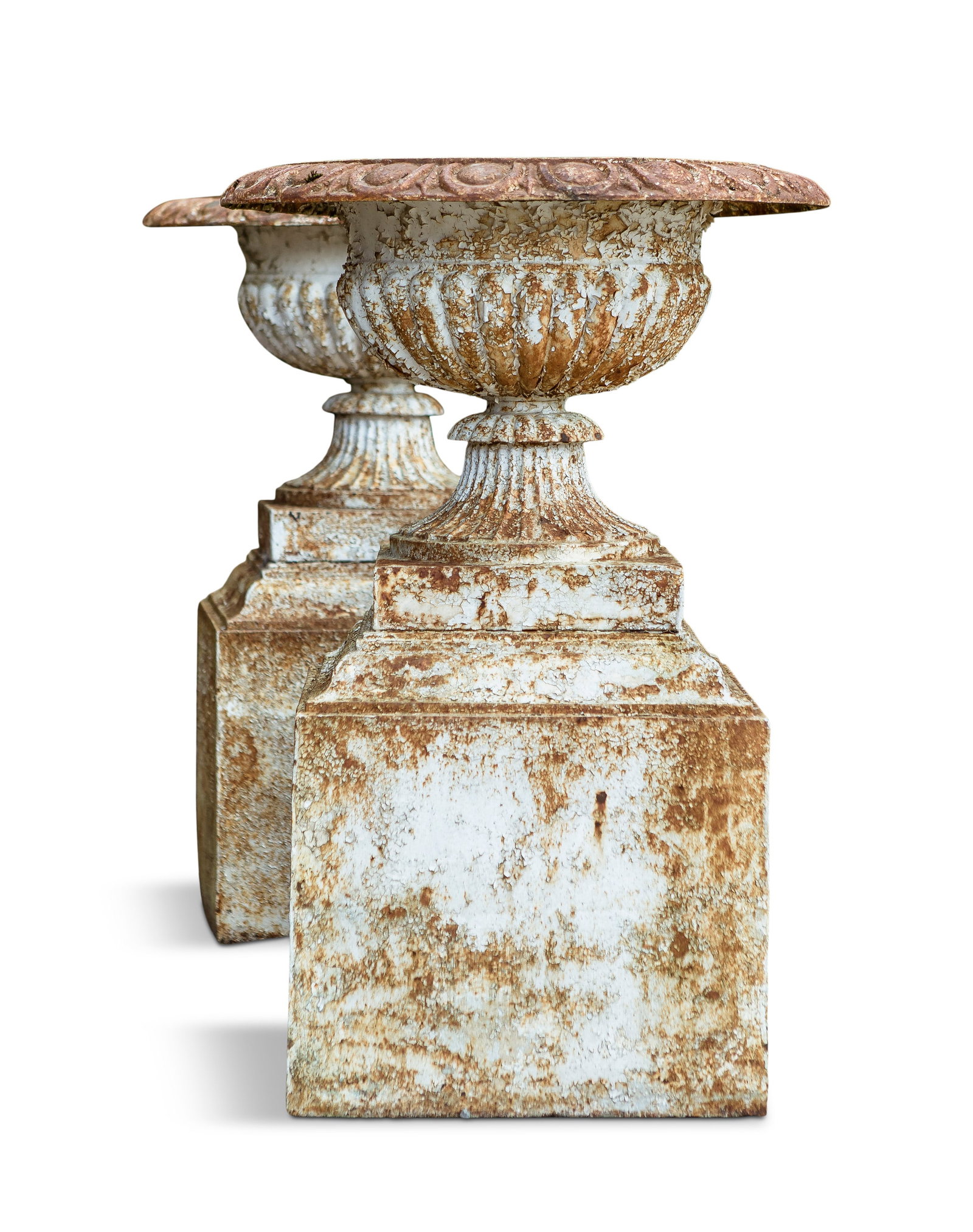 A PAIR OF CAST IRON WHITE PAINTED GARDEN URNS ON PEDESTALS, of campagna form, with outset rim, over: A PAIR OF CAST IRON WHITE PAINTED GARDEN URNS ON PEDESTALS, of campagna form, with outset rim, over demi-fluted body, on waisted socle, raised on square pedestal bases. The urns 90cm high, 60cm diamet