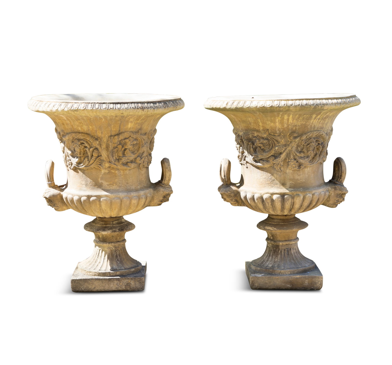 A PAIR OF MODERN COMPOSITE STONE URNS, of campagna form, out-turned rims with egg and dart: A PAIR OF MODERN COMPOSITE STONE URNS, of campagna form, out-turned rims with egg and dart moulding, masked side carrying handles, the bodies with scrolling foliage, demi fluted on waisted socle and s