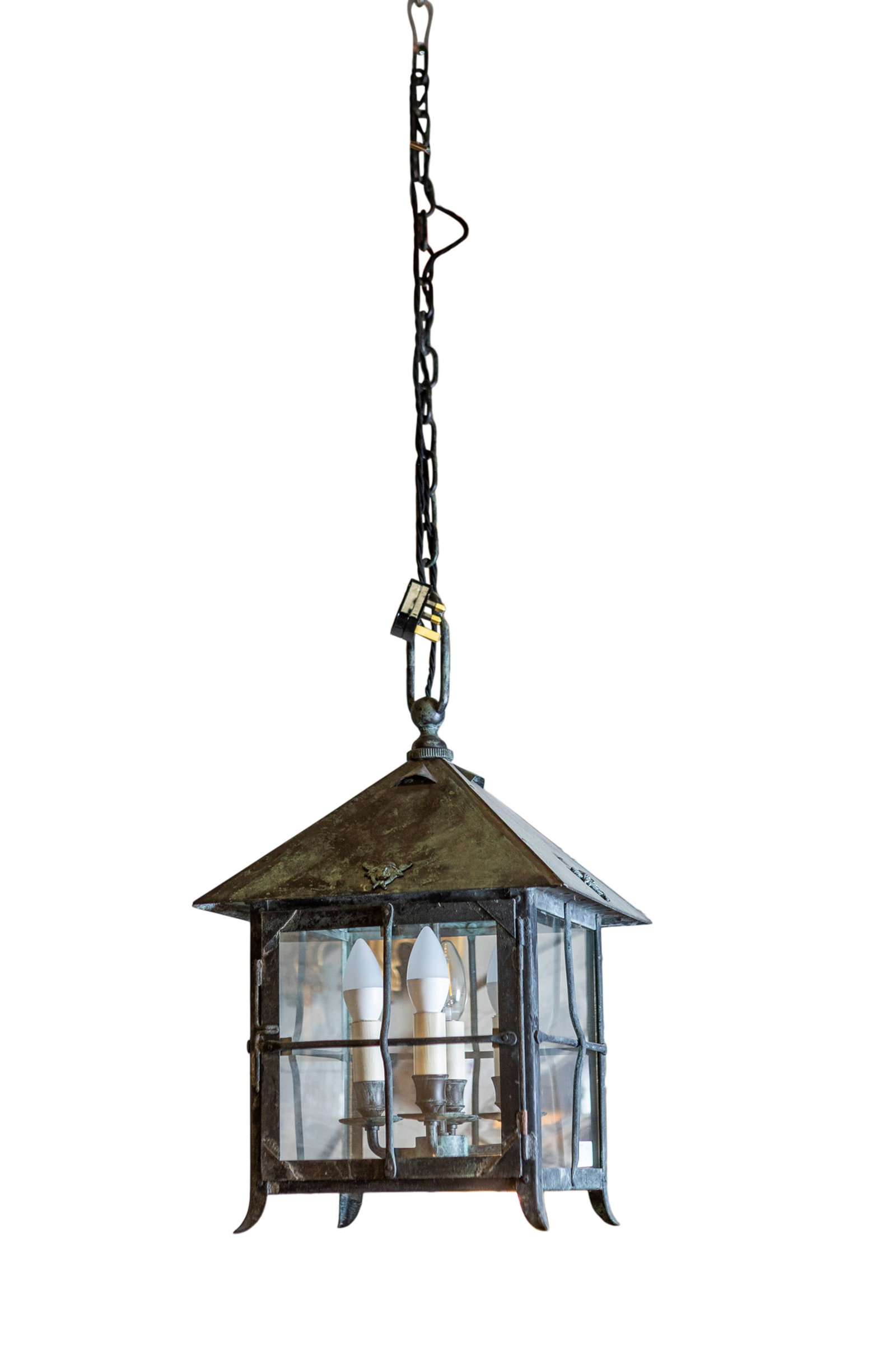 A BRASS FRAMED HALL LANTERN of square form, with arched top, over segmented panel sides, fitted: A BRASS FRAMED HALL LANTERN of square form, with arched top, over segmented panel sides, fitted with four arm faux candle sconces. 52cm high, 30cm wide