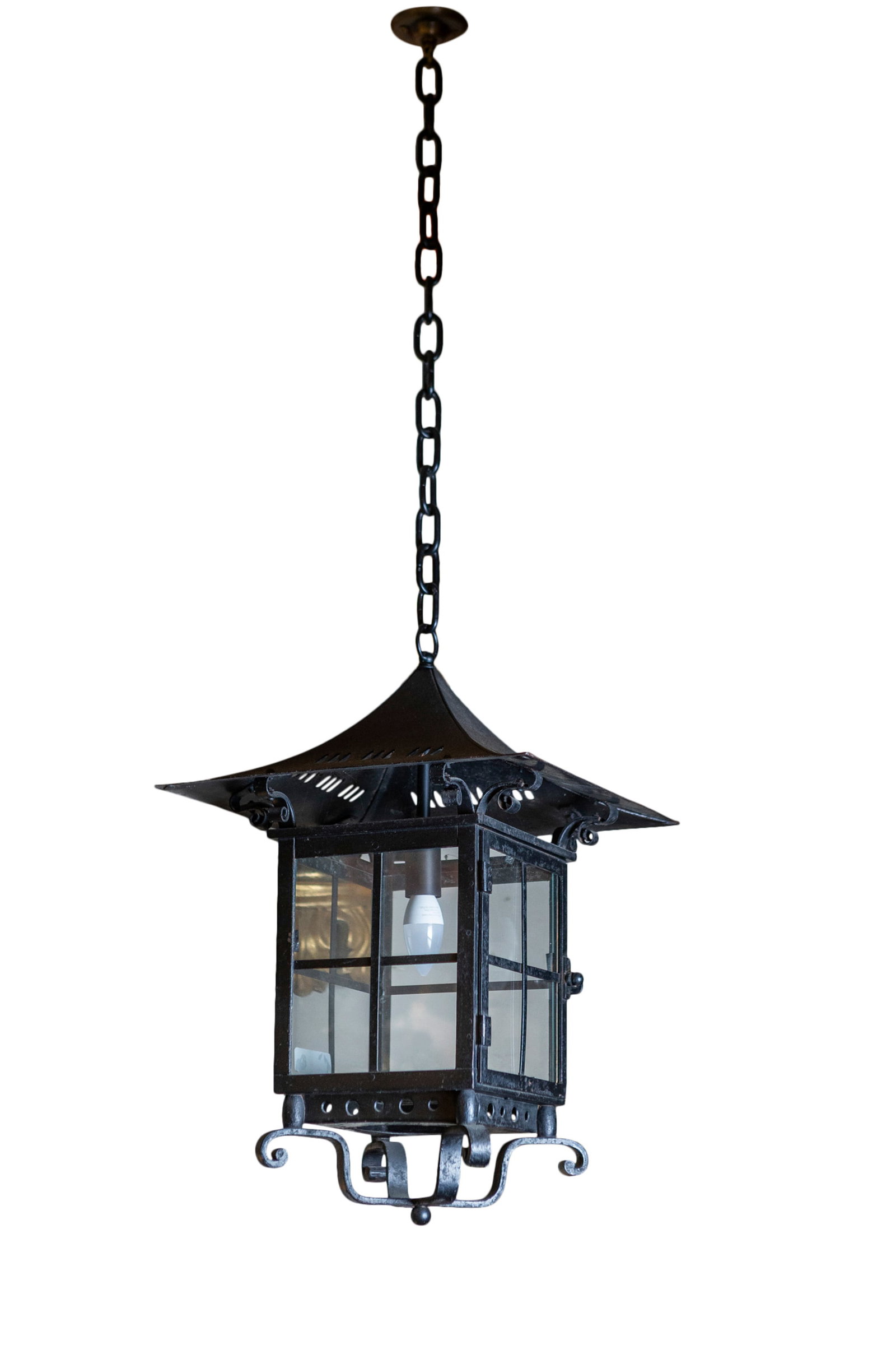A BRASS FRAMED HALL LANTERN with outset hood, over square glazed panels, and applied scroll work: A BRASS FRAMED HALL LANTERN with outset hood, over square glazed panels, and applied scroll work base. 40cm high, 35cm wide