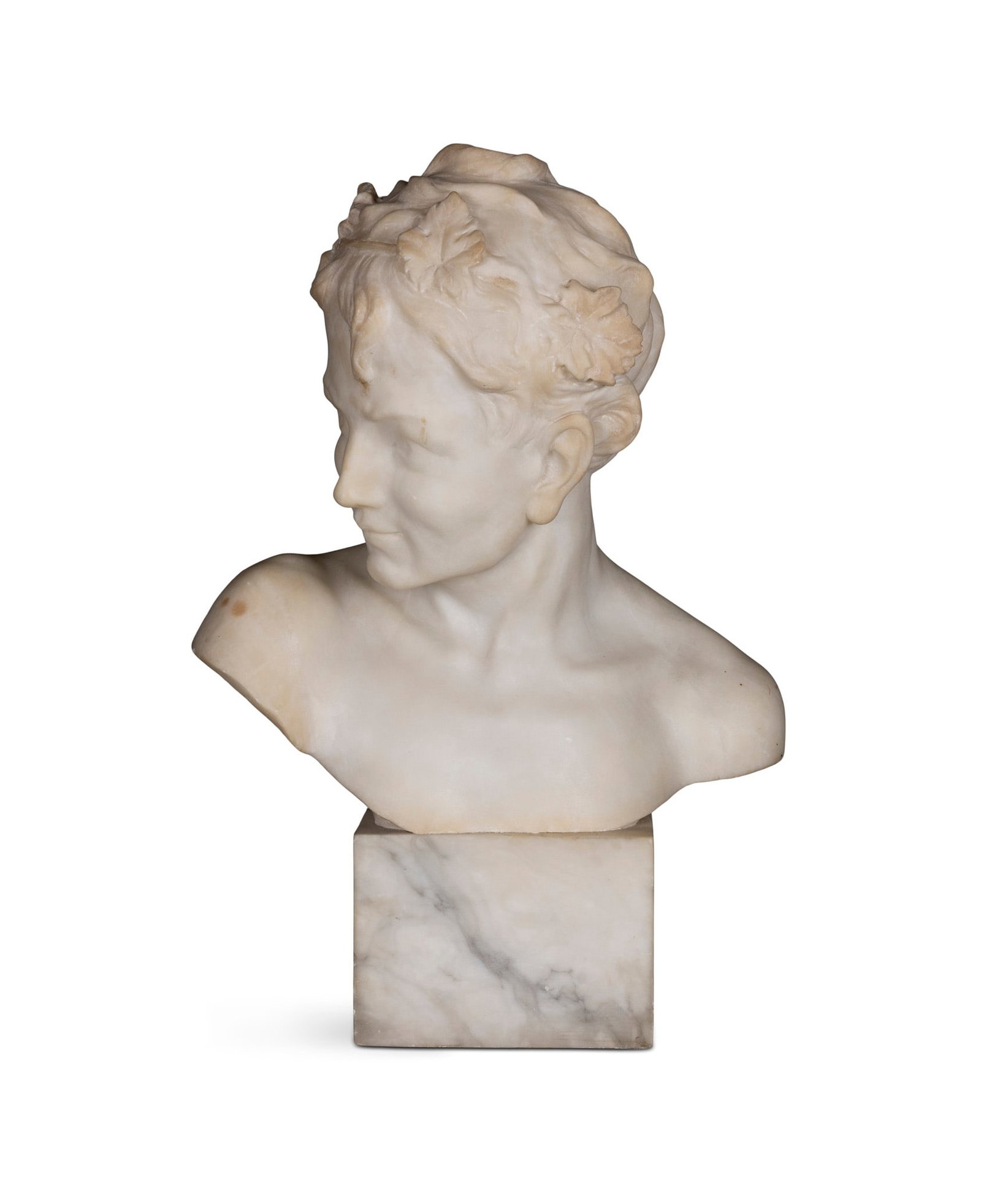 AN ITALIAN MARBLE BUST OF A CLASSICAL FIGURE, ivy leaves in his hair, likely the god Dionysus (or: AN ITALIAN MARBLE BUST OF A CLASSICAL FIGURE, ivy leaves in his hair, likely the god Dionysus (or Bacchus/Liber in Roman mythology), on square base. Signed 'Pugi' 40cm high