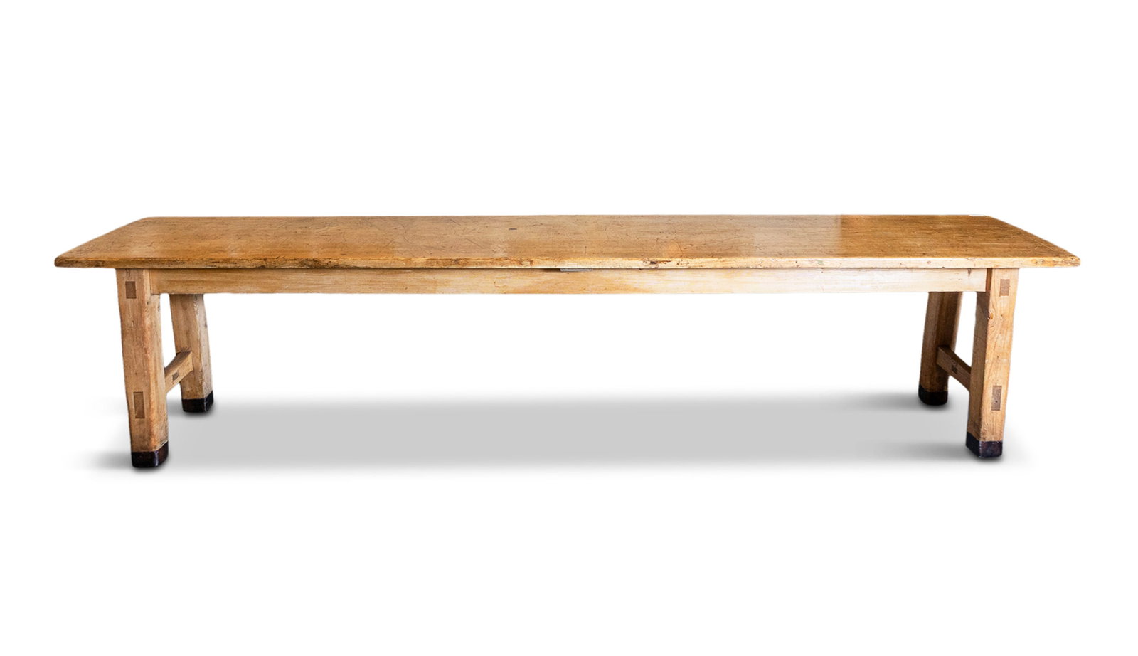 A LARGE PINE REFECTORY TABLE the plain panel top and frieze raised on square legs joined by (1 of 1)