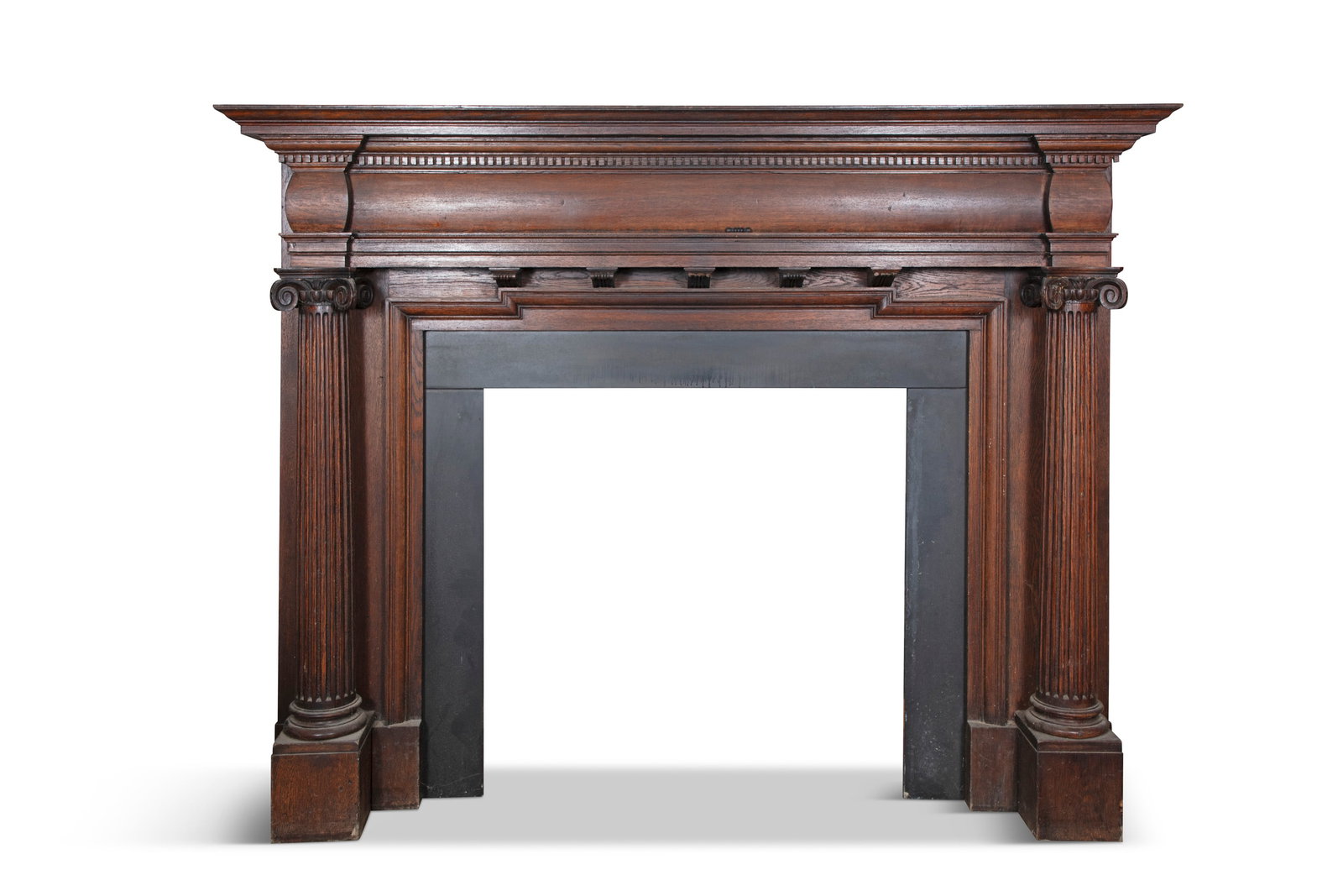 A NEOCLASSICAL STYLE STAINED OAK AND SLATE MANTELPIECE, the dentil cornice above a plain frieze (1 of 2)
