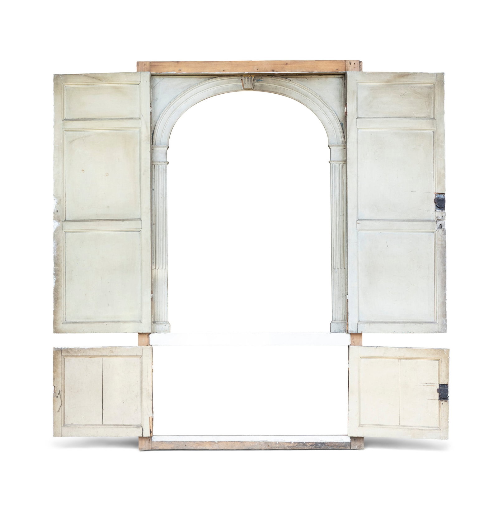 A GEORGIAN WHITE PAINTED, CARVED WOOD INTERNAL PRESS, enclosing a central architrave of arched form: A GEORGIAN WHITE PAINTED, CARVED WOOD INTERNAL PRESS, enclosing a central architrave of arched form flanked by channelled pilasters and centred by a carved keystone section, the architrave flanked by 