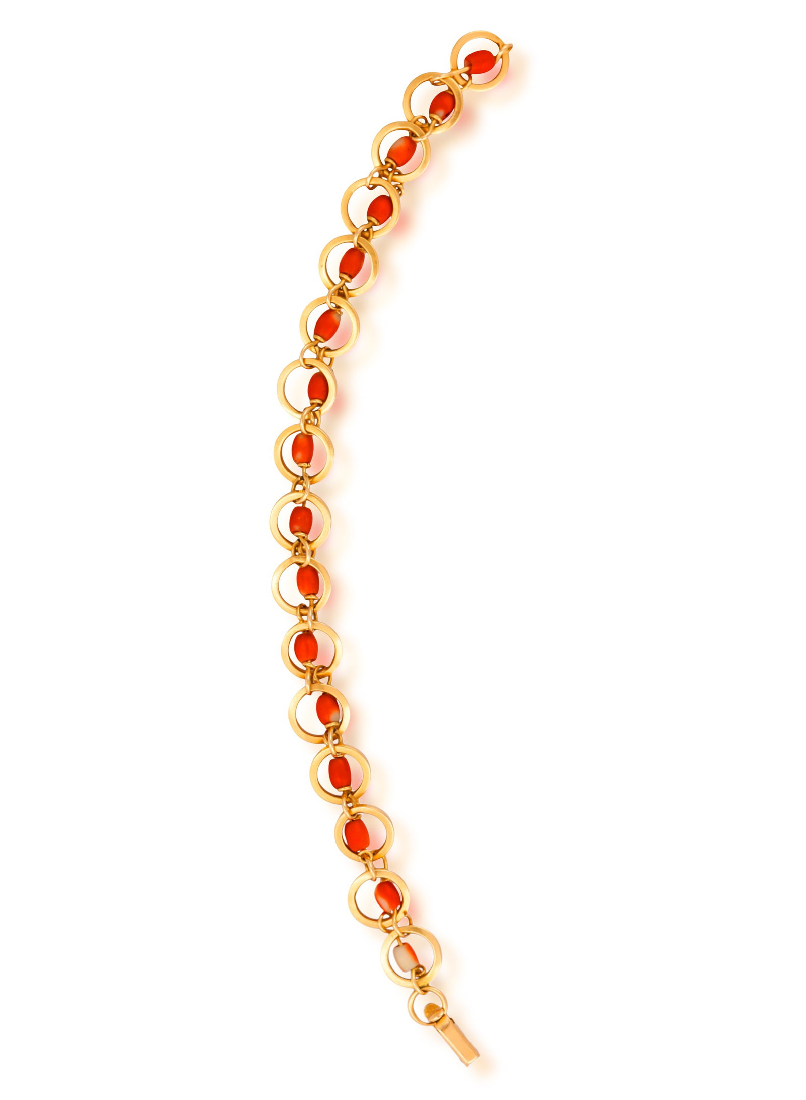 A CORAL AND GOLD BRACELET • A single row of elongated coral beads • mounted in gold R: A CORAL AND GOLD BRACELET • A single row of elongated coral beads • mounted in gold • length 22cm **Prospective buyers are advised that several countries prohibit the importation of 