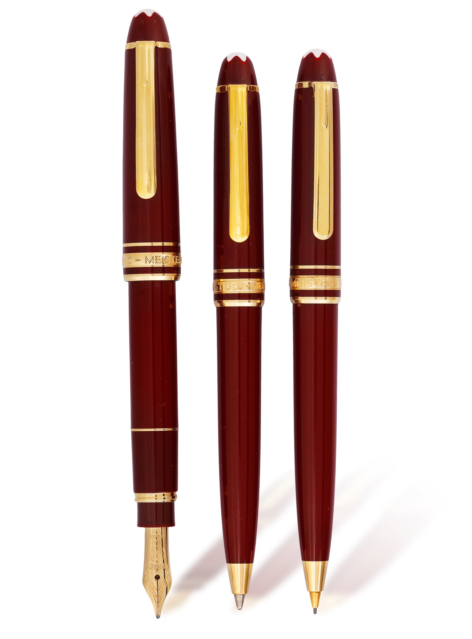 MONTBLANC: A 'MEISTERSTRUCK' BURGUNDY PEN AND PENCIL SET • A gold plated and lacquer fountain (1 of 3)