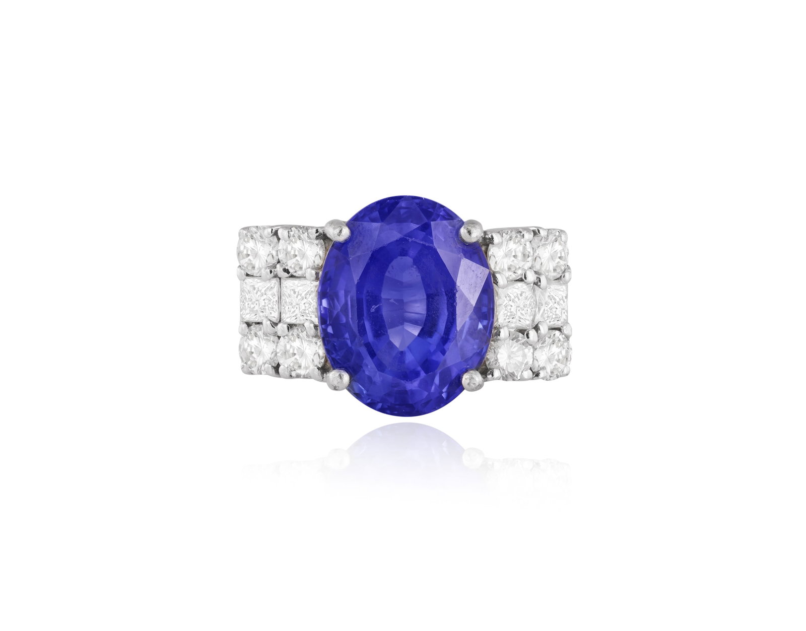 A TANZANITE AND DIAMOND DRESS RING • An oval-shaped tanzanite, approx. 5.20cts • square: A TANZANITE AND DIAMOND DRESS RING • An oval-shaped tanzanite, approx. 5.20cts • square and brilliant-cut diamond shoulders, approx. 1.10cts total • mounted in 18K gold • ring size