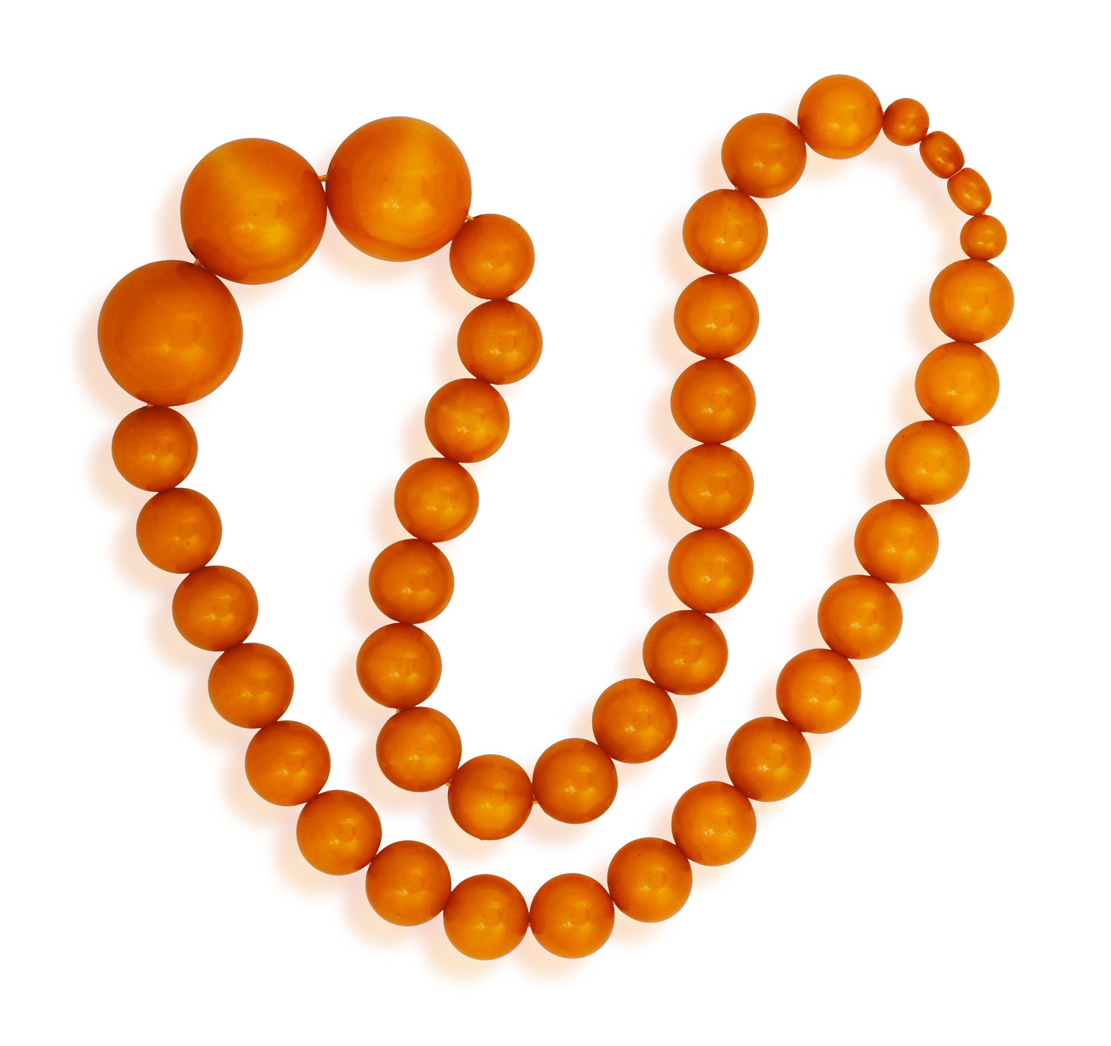 AN AMBER BEAD NECKLACE • Single row of graduated amber beads • length approx. 67.5cm (1 of 4)