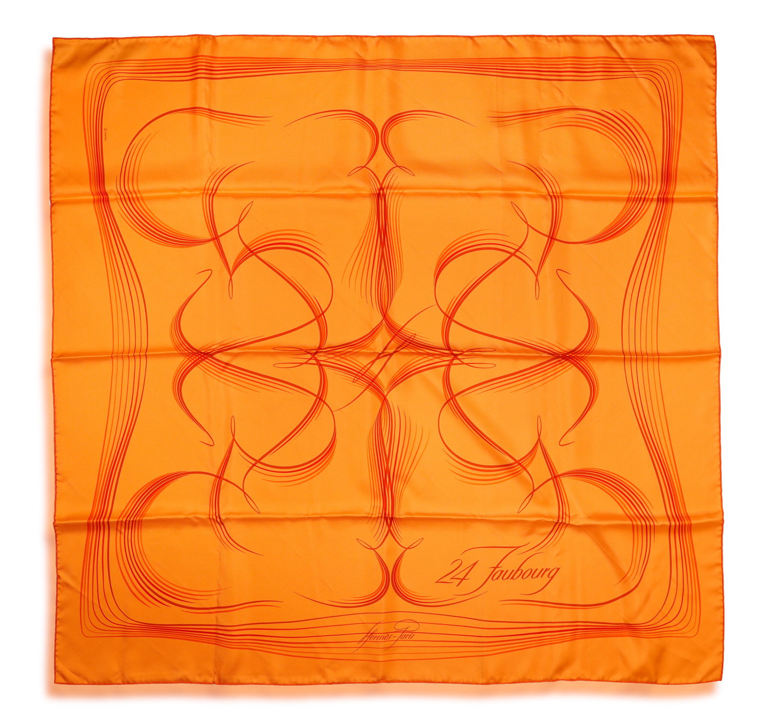 HERMÈS: A SILK SCARF ‘24 FAUBOURG' • Of orange hues with swirl detailing •: HERMÈS: A SILK SCARF ‘24 FAUBOURG' • Of orange hues with swirl detailing • signed Hermès Paris • designed by Benoit Pierre Emery • measuring approx. 90 x 90cm *