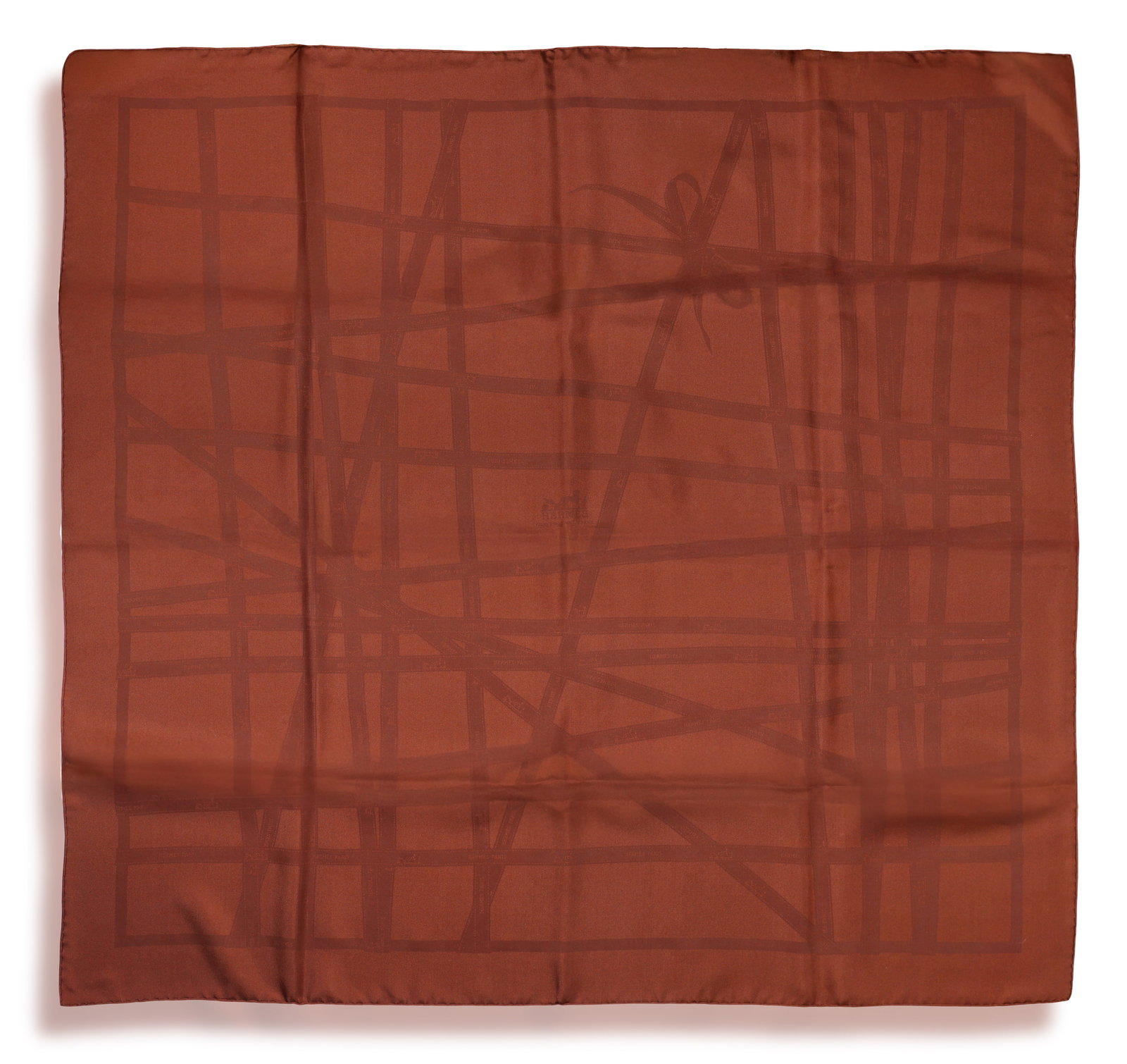 HERMÈS: A SILK SCARF 'BOLDUC RIBBON' • Bow motif • deep brown hues • signed H: HERMÈS: A SILK SCARF 'BOLDUC RIBBON' • Bow motif • deep brown hues • signed Hermès • with maker's case • measuring approx. 90 x 90cm *This lot is sold without a