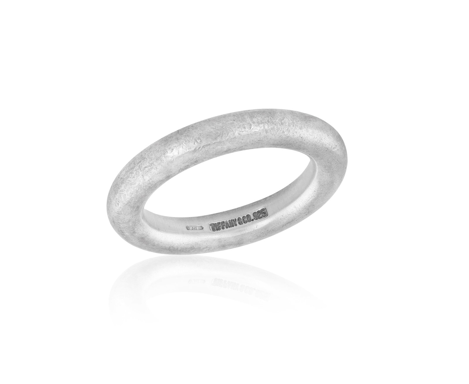 TIFFANY & CO.: A SILVER RING • A plain band • in silver 925 • signed Tiffany & Co.: TIFFANY & CO.: A SILVER RING • A plain band • in silver 925 • signed Tiffany & Co. • Italian registry mark • with maker's pouch • ring size L *This lot is sold with