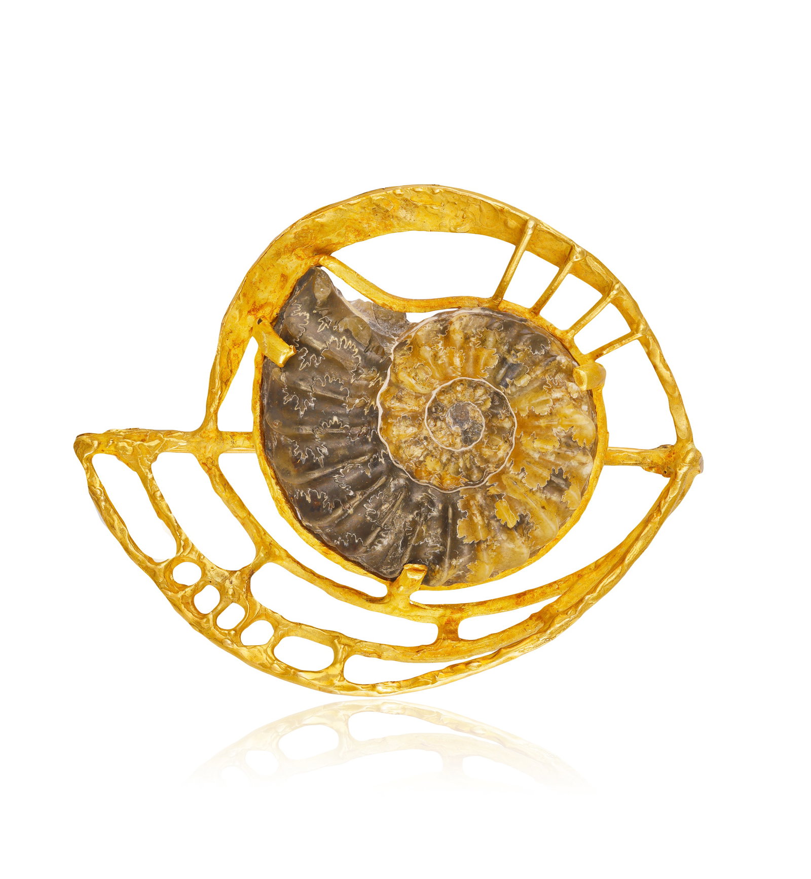 A GOLD FOSSIL SHELL BROOCH • Set with a fossil shell • mounted in 18K gold • (1 of 2)