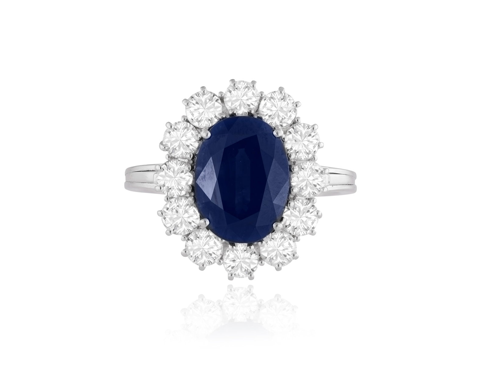 A SAPPHIRE AND DIAMOND CLUSTER RING • Oval-shaped sapphire, approx. 4.20cts • (1 of 3)