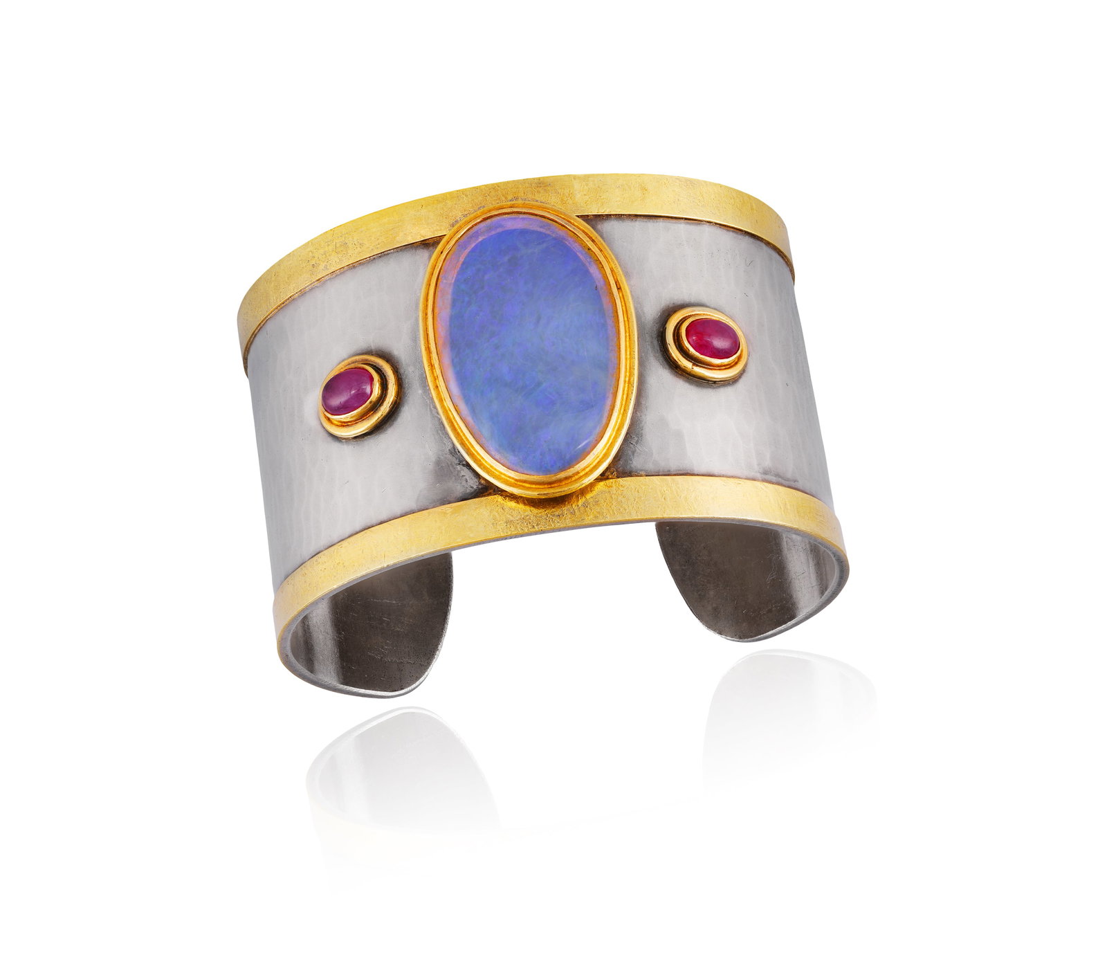 AN OPAL AND RUBY CUFF BANGLE • Oval-shaped opal, approx. 31 x 20mm • two oval-shaped rub (1 of 2)