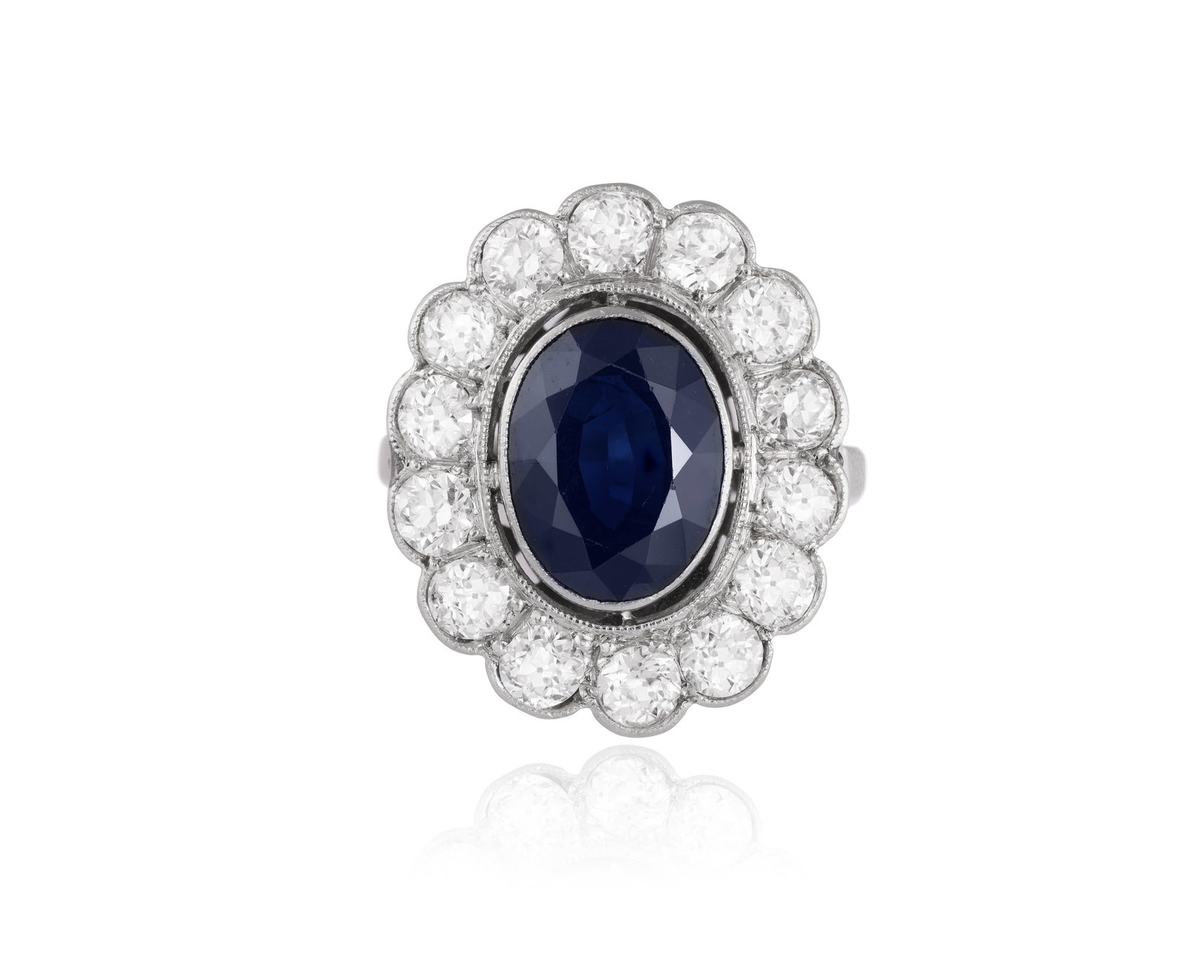 A SAPPHIRE AND DIAMOND CLUSTER RING • An oval-shaped sapphire, approx. 3.00cts • old bri (1 of 3)