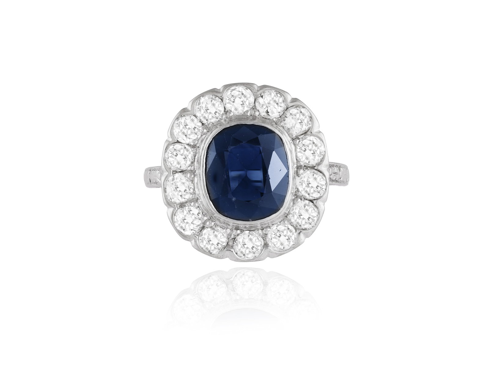 A SAPPHIRE AND DIAMOND CLUSTER RING • Cushion-shaped sapphire, approx. 2.00cts • old (1 of 3)
