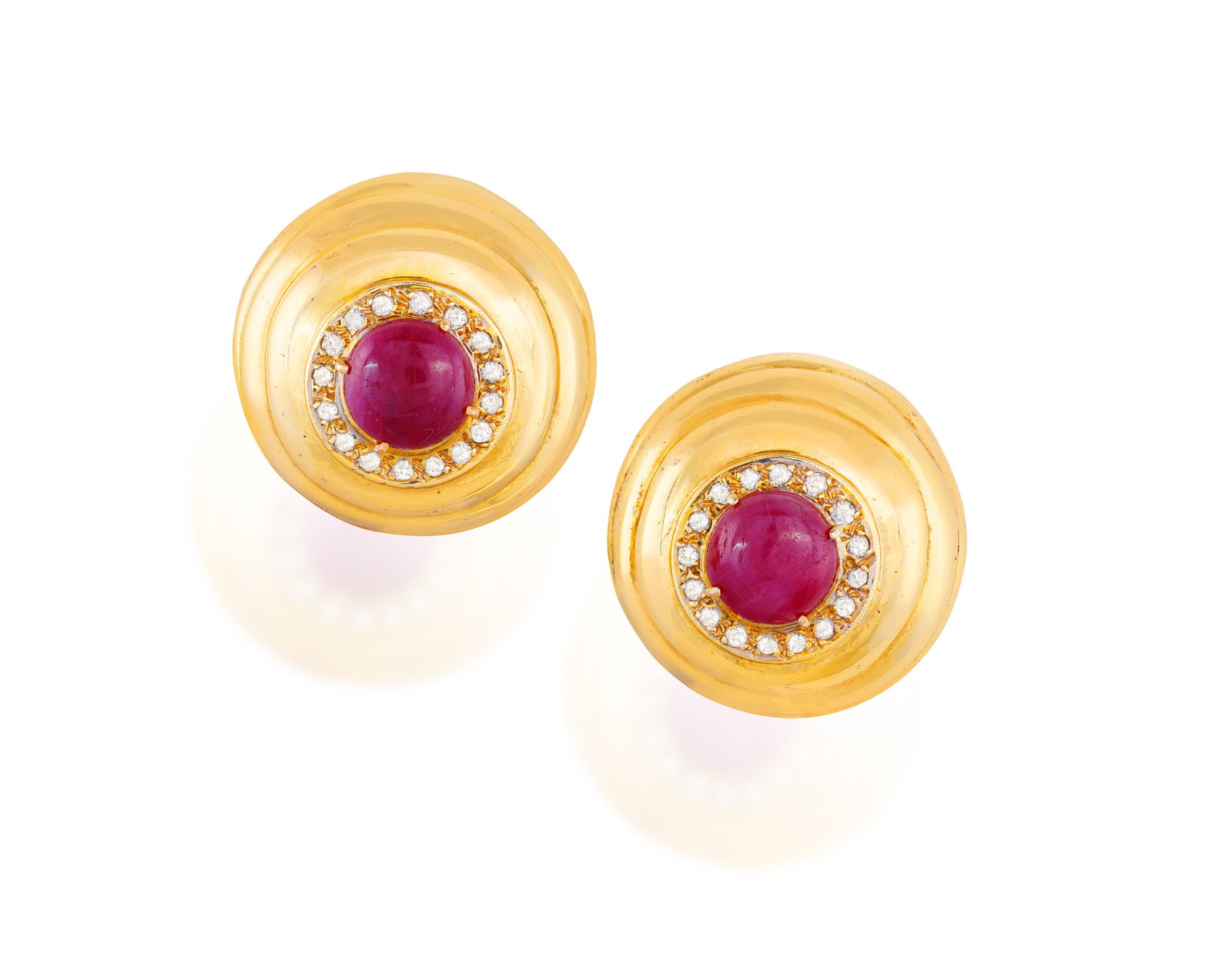 A PAIR OF RUBY AND DIAMOND EARCLIPS • Two circular-cut ruby cabochons, approx. 7.80cts total (1 of 2)