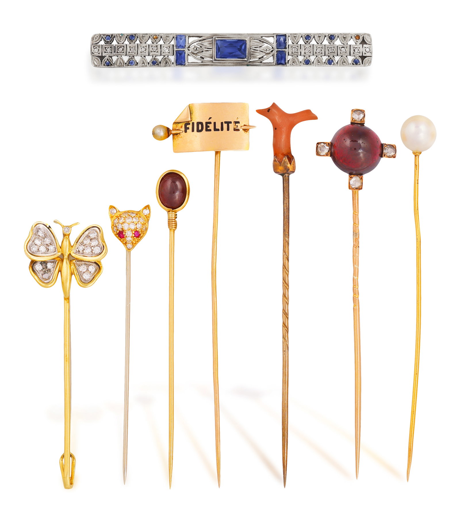 A GROUP OF SEVEN PIN AND A BAR-BROOCH • The first with a circular-cut garnet cabochon •  (1 of 4)