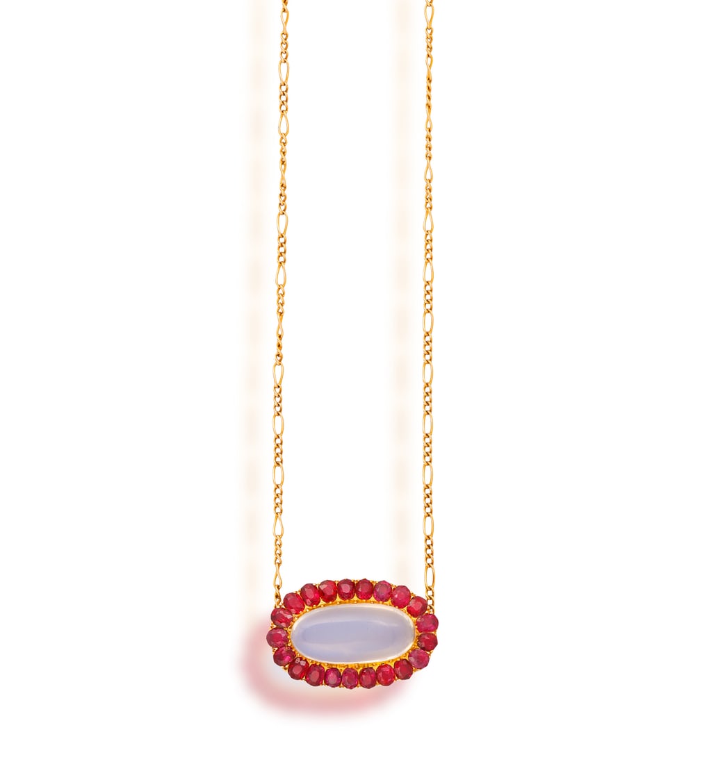 A MOONSTONE AND RUBY NECKLACE • An elongated oval-shaped moonstone cabochon, approx. 9.00cts & (1 of 3)