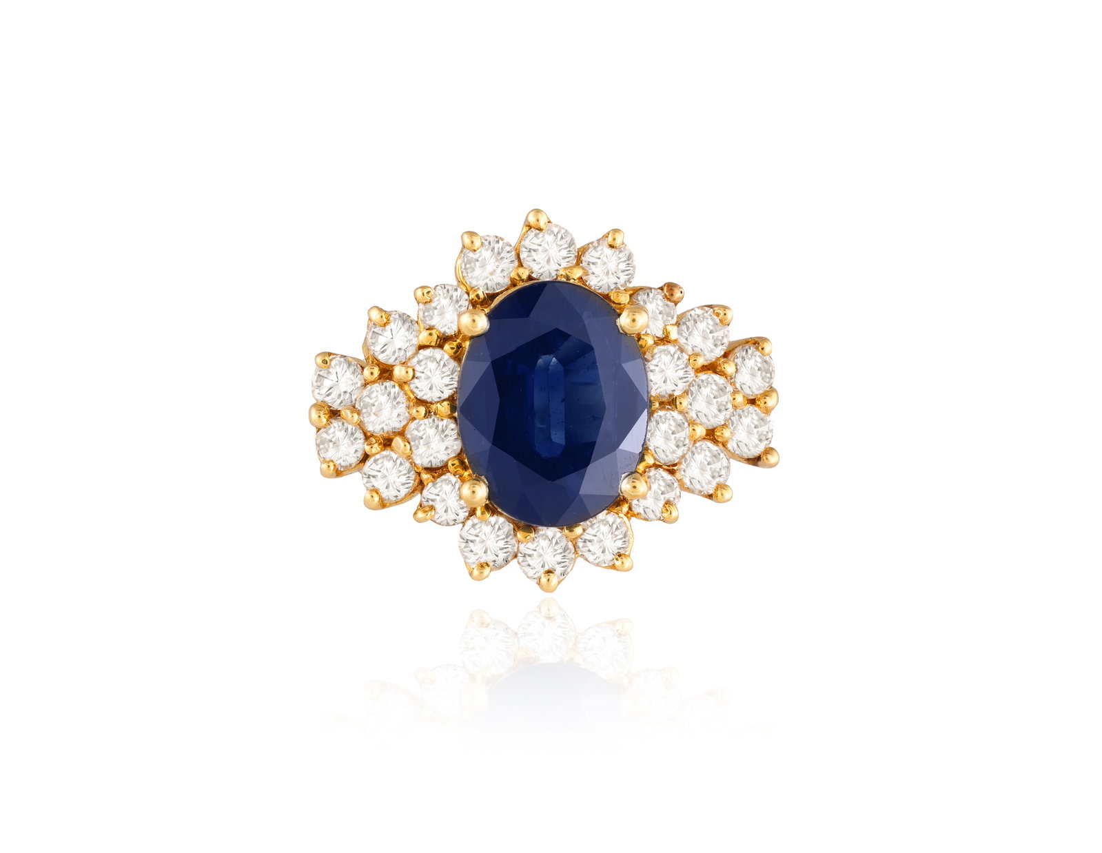 A SAPPHIRE AND DIAMOND CLUSTER RING • An oval-shaped sapphire, approx. 2.40cts •: A SAPPHIRE AND DIAMOND CLUSTER RING • An oval-shaped sapphire, approx. 2.40cts • brilliant-cut diamond surround • mounted in 18K gold • ring size L