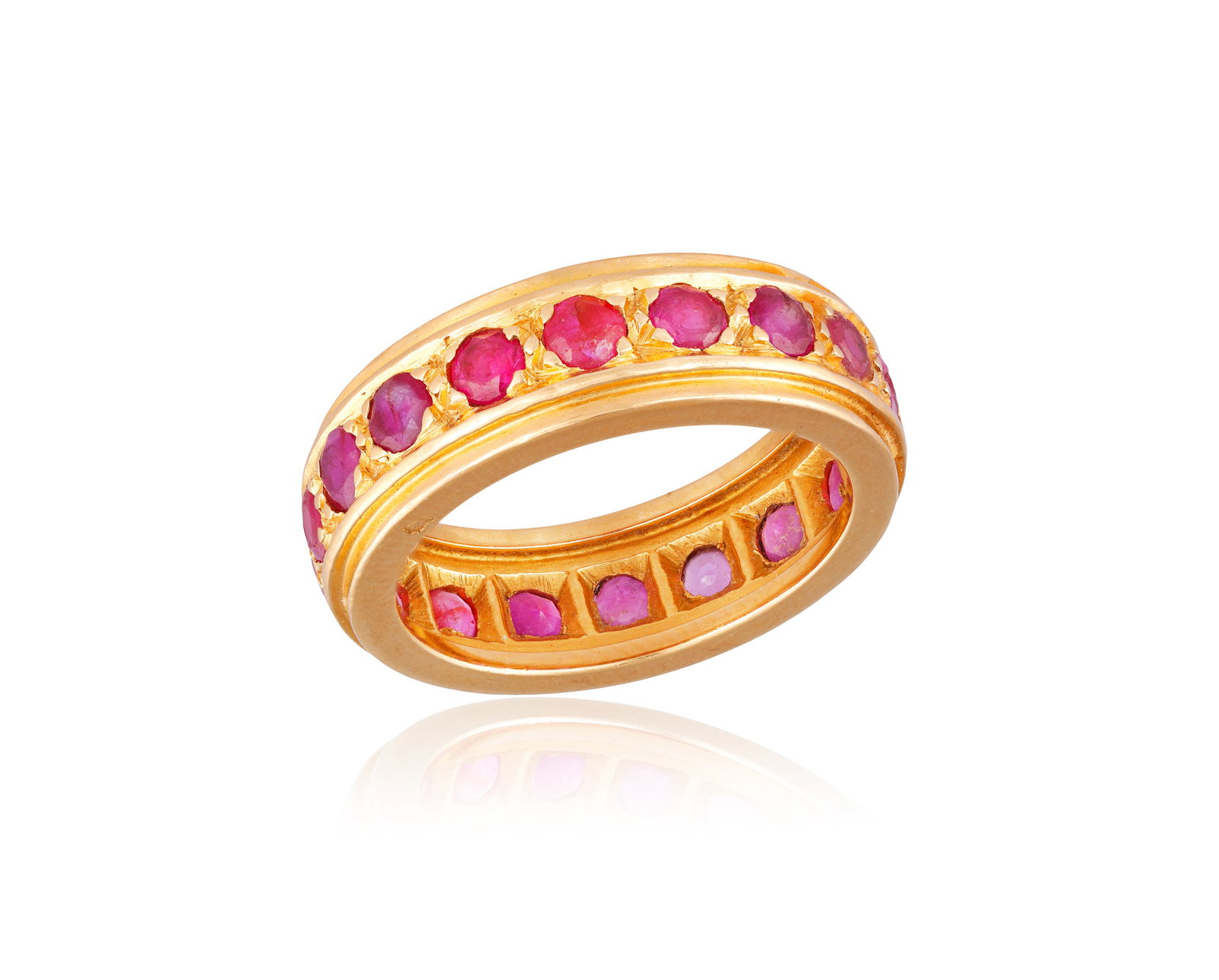 A RUBY ETERNITY RING • Circular-cut rubies • mounted in 18K gold • French assay: A RUBY ETERNITY RING • Circular-cut rubies • mounted in 18K gold • French assay mark • ring size J½ * This lot is sold without a reserve