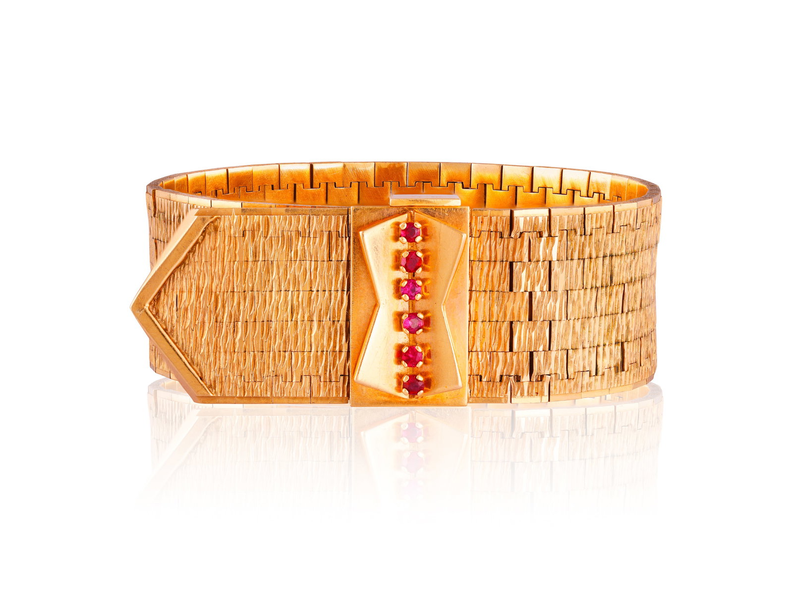 A 9K GOLD AND RUBY BRACELET, 1973 • Six circular-cut ruby accents • mounted in 9K gold: A 9K GOLD AND RUBY BRACELET, 1973 • Six circular-cut ruby accents • mounted in 9K gold • English hallmarks for Birmingham • with maker's mark 'NBS' • length 18.4cm