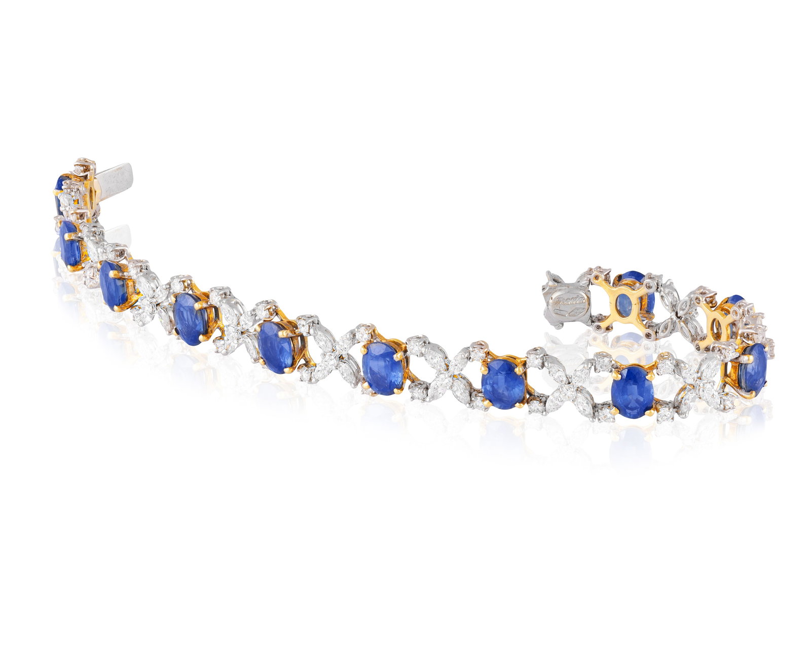 A SAPPHIRE AND DIAMOND BRACELET • Eleven oval-shaped sapphires, approx. 16.00cts total •: A SAPPHIRE AND DIAMOND BRACELET • Eleven oval-shaped sapphires, approx. 16.00cts total • brilliant and marquise-shaped diamonds, approx. 6.50cts total • mounted in 18K gold • s
