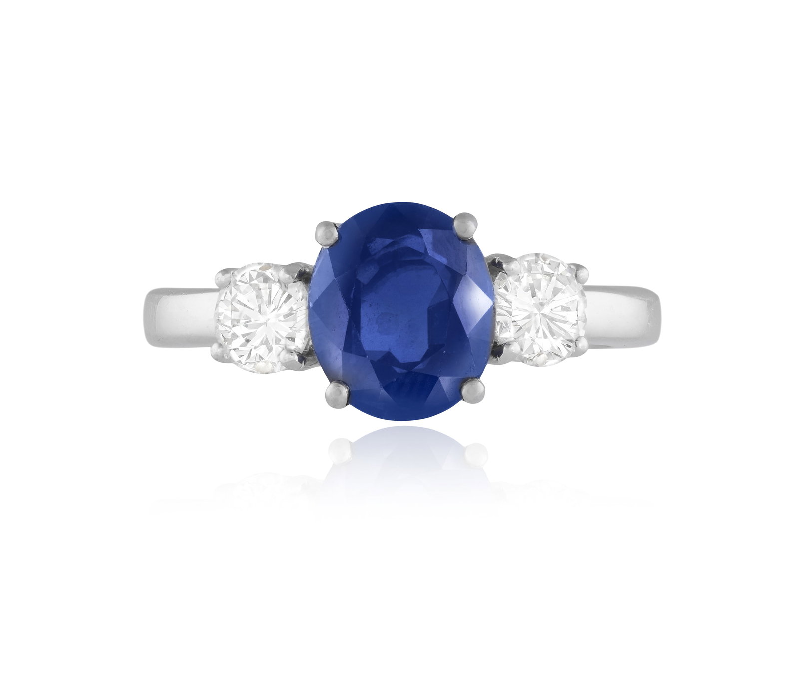 A SAPPHIRE AND DIAMOND THREE-STONE RING • Oval-shaped sapphire, approx. 3.20cts • two (1 of 3)
