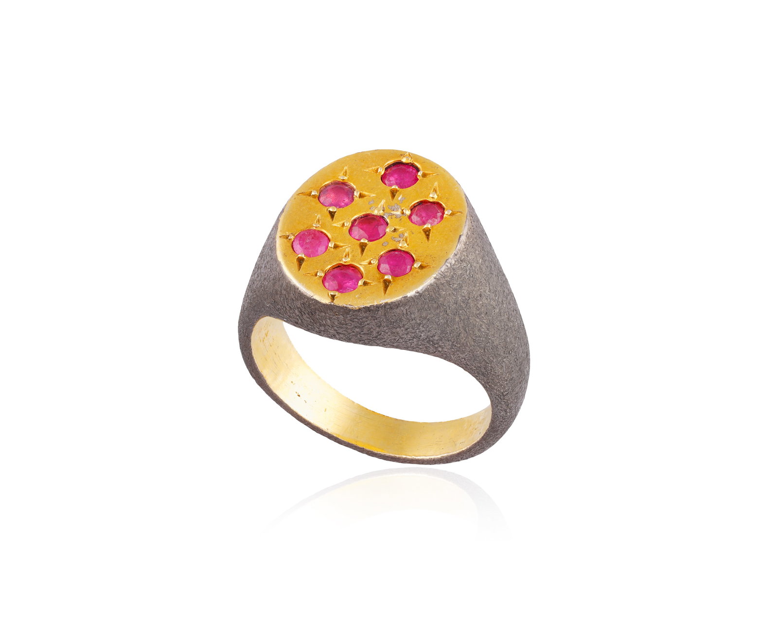 A RUBY RING • Of bi-coloured design • seven circular-cut rubies • ring size O½: A RUBY RING • Of bi-coloured design • seven circular-cut rubies • ring size O½ *This lot is sold without a reserve